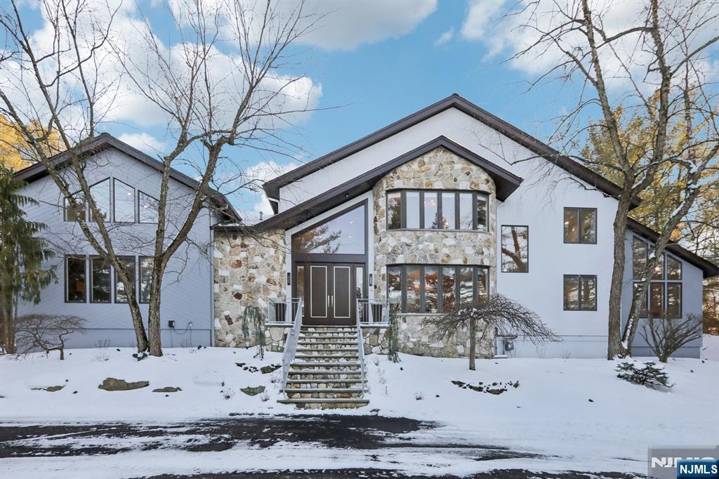 This is THE ONE that has it ALL! LOCATION MATTERS: 1/2 Acre on one of RIKER HILL's Most Prestigious Streets. SIZE MATTERS: This 6 Bedroom,5 Full bath + One half bath home boasts approx. 6500 sq ft of Living Space incl Finished Basement plus 3-car Garage. STYLE MATTERS: Forever-in-Demand Custom CONTEMPORARY known for its GREAT ROOM with 25 ft CATHEDRAL Ceiling, Gas FP and Tons of NATURAL LIGHT. Home Features an Impressive600 sq ft Chef's BRIGHT KITCHEN with10 Ft Long Quartzite TWIN Islands, Gourmet Wolf/Subzero SS Appliances (incl. 3 ovens and 2 Dishwashers) Open to LARGE Family Room with 2nd Gas Fireplace and Multiple Sliders flowing out to Expansive TREX Deck and STONE Patio. Main Floor Bedroom/Office and Full Bath perfect for MULTI-GENERATIONAL Living. HUGE 1200+ Sq Ft MASTER EN-SUITE with NEW SPA-LIKE Bath, Double-Sided Fireplace, 2 WIC, 2nd Laundry and Sitting Room/Office. Separate "wing" includes 3 Bedrooms and 2 RENOVATED Baths. FINISHED BASEMENT incl Rec Room, Bedroom #6, FULL Bath, Exercise Room, Laundry #2 and TONS of Storage. Additional Highlights: Main Floor Brazilian Walnut floors, 5 SLIDERS out to DECK/PATIO, Whole House GENERATOR, Built-in Speaker system, Tesla Wall Charger, new driveway and much more!! This is a VERY SPECIAL Property with spectacular SUNSET VIEWS backing up to COUNTY PARKLAND!