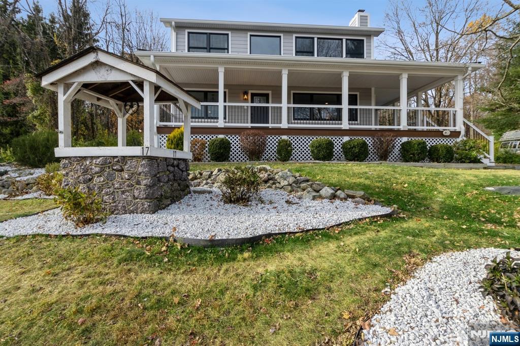 Beautifully updated Colonial w/ modern finishes & open layout, features rich hardwood floors, large windows for plenty of sunlight, elegant crown molding & trim details, & deck overlooking the private backyard, lovely landscaping & brand new pool. Located in Montville Township w/ Boonton mailing address. In the top rated Montville school system. Beyond the wrap-around front porch, the living space flows from the large living room w/ a wood-burning fireplace to the family room & a sunlit formal dining room w/ windows all around. A wide arched doorway brings you into the state-of-the-art kitchen equipped w/ quartz counters, tile backsplash, stainless steel appliances, a breakfast bar, generous cabinetry & full pantry closet. Off the kitchen is a convenient laundry room & a powder room. A doorway to the deck brings you outside to enjoy peaceful privacy in the perfect setting for cookouts, relaxing & entertaining. The second floor has a large primary bedroom suite featuring a vaulted ceiling, a picture window w/ a panoramic view of the countryside, a nice yard w/ a new pool, huge walk-in closet & ensuite bathroom w/ an oversized glass shower. Two additional bedrooms share a full bathroom w/ a dual-sink vanity. To top it all off, a sprawling finished basement offers loads of storage & recreation space. There is also a detached garage & a long driveway for extra parking. Close to major highways, transportation, shopping, parks, schools, & places of worship.