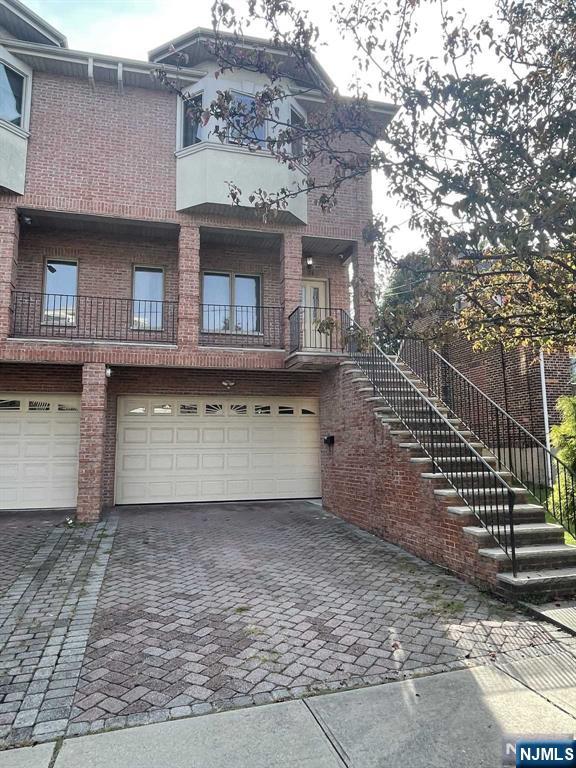 Location, Location, Location! This stunning duplex is located on the EAST side of town. All doors are imported from Italy, adding an elegant touch throughout. The spacious living room features a custom-built wall unit and a fireplace. The beautiful kitchen boasts granite countertops and stainless steel appliances, with a sliding glass door leading to the deck. The master bedroom includes an en-suite bathroom with a separate shower stall and a Jacuzzi. All bedrooms are equipped with custom-made, walk-in California closets with cedar wood. There are two additional large bedrooms and a full bathroom. A skylight brightens the hallway, the finished ground floor includes a full bath, and another sliding glass door to the backyard offers plenty of outdoor space: 2-car garage and central air. Entire house has a water filter/softener, built-in reverse osmosis in the kitchen and refrigerator water supply, a tankless hot water heater, an electrical panel pre-wired for a portable generator, and added split unit a/c in the basement. The list of upgrades goes on! Near restaurants, shops, and schools, with easy access to NYC. Bus stop is less than a minute's walk away.