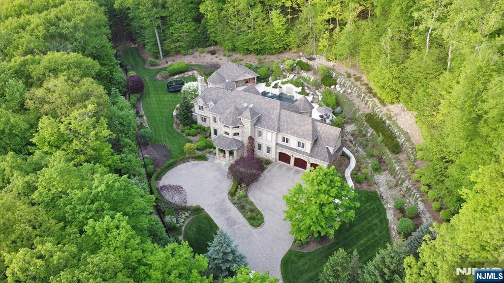 Nestled against the breathtaking backdrop of Ramapo Mountain State Forest, this exceptional 10.92-acre estate redefines luxury living. The homeâ€™s resort-like backyard is an entertainerâ€™s dreamâ€”featuring a stunning pool, spa, outdoor kitchen, full service cabana and lounge areas designed for memorable gatherings or serene relaxation. Custom-crafted with meticulous attention to detail, the residence seamlessly blends elegance and comfort, offering panoramic views from every window, expansive living spaces, an elevator to all levels, and top-tier finishes throughout. Whether you seek a private sanctuary or a showplace for entertaining, this one-of-a-kind home offers it allâ€”alongside direct access to miles of pristine forest trails. Surrounded by nature, yet close to shops, dining, and top-rated schools, this is the best of both worlds.