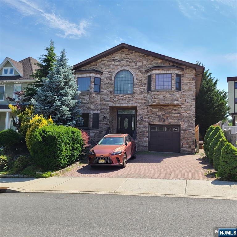 Builder's Home ! Spacious One Family Home with an In-Law Suite with it's own private entrance. First Floor has a beautiful entry foyer, spacious living room with a wood burning fireplace, formal dining room and a kitchen with stainless steel appliances, granite counters and oak cabinets with a center island. The Second Floor has a Primary Bedroom with a huge walk in closet and primary bathroom with soaker tub and shower. Two more large bedrooms with an additional bath and sitting area, den or office space. The basement has a perfect in-law guest suite with it's own private entrance and additional bath. There is also a lovely backyard great for hosting get togethers with a gas grill and wood burning fireplace.