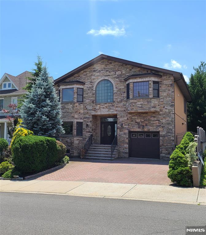 Builder's Home ! Spacious One Family Home with an In-Law Suite with it's own private entrance. First Floor has a beautiful entry foyer, spacious living room with a wood burning fireplace, formal dining room and a kitchen with stainless steel appliances, granite counters and oak cabinets with a center island. The Second Floor has a Primary Bedroom with a huge walk in closet and primary bathroom with soaker tub and shower. Two more large bedrooms with an additional bath and sitting area, den or office space. The basement has a perfect in-law guest suite with it's own private entrance and additional bath. There is also a lovely backyard great for hosting get togethers with a gas grill and wood burning fireplace.