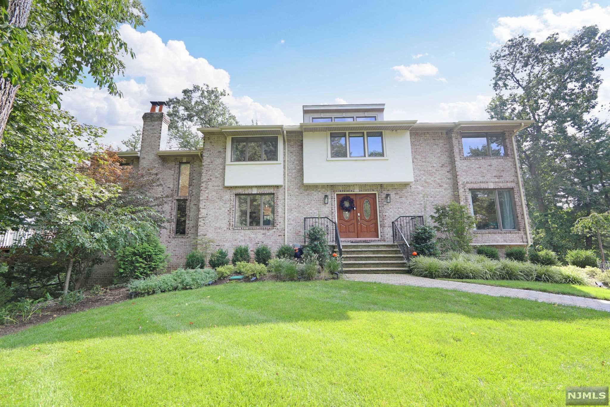 Contemporary and Modern Colonial that has it ALL! Sitting on a quiet cul-de-sac in a dream location with a private and lush backyard... you will love living here. Comfortable layout with spacious rooms throughout. SO MANY RECENT UPGRADES, this home is completely move-in-ready and features 5 bedrooms and 3 full bathrooms. Primary Bedroom boasts a brand-new Bathroom with a custom Steam Shower for ultimate relaxation. White kitchen with granite countertops with large center island and SS appliances that is Open-Concept to a fabulous Family Room with Soaring Ceilings and brick FP. Huge deck off of FR with incredible private views. 5th bedroom on the main floor makes for comfortable guest room or home office. Basement features wet bar, family room, and walk-out to the backyard. Brand New HVAC (dual zone) and water softener. 2 car garage. Another bonus - This is a SMART home controlled by your phone! Woodcliff Lake is known for excellent schools (walking distance) and shopping galore.