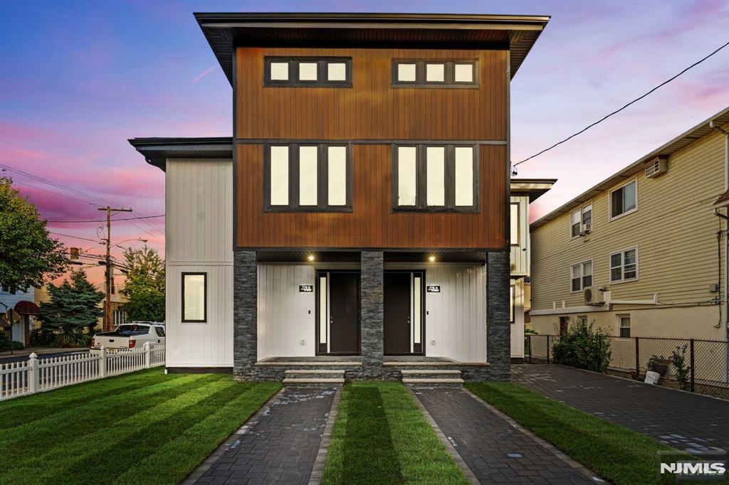 Welcome to this contemporary modern home! This brand-new construction features 3 spacious bedrooms and 3.5 stylish bathrooms. The open-concept layout offers high ceilings and natural light. The gourmet kitchen, with high-end appliances, a large island, and leather finish granite countertops, is perfect for cooking and entertaining. Each bedroom is well-sized, and the en-suite offers a walk-in closet, stand up shower, and freestanding soaking tub and stand-up shower. Enjoy the landscaped front yard, ideal for relaxation. Additional highlights include a dedicated laundry room, long driveway with EV charging station, and smart home tech for thermostat, lights, doorbell, and locks. The living and dining rooms feature a double-sided CLEARion Elite 50 electric fireplace. Located in a desirable neighborhood with NYC transportation right outside, parks, and top-rated schools nearby, this home blends luxury with practicality.