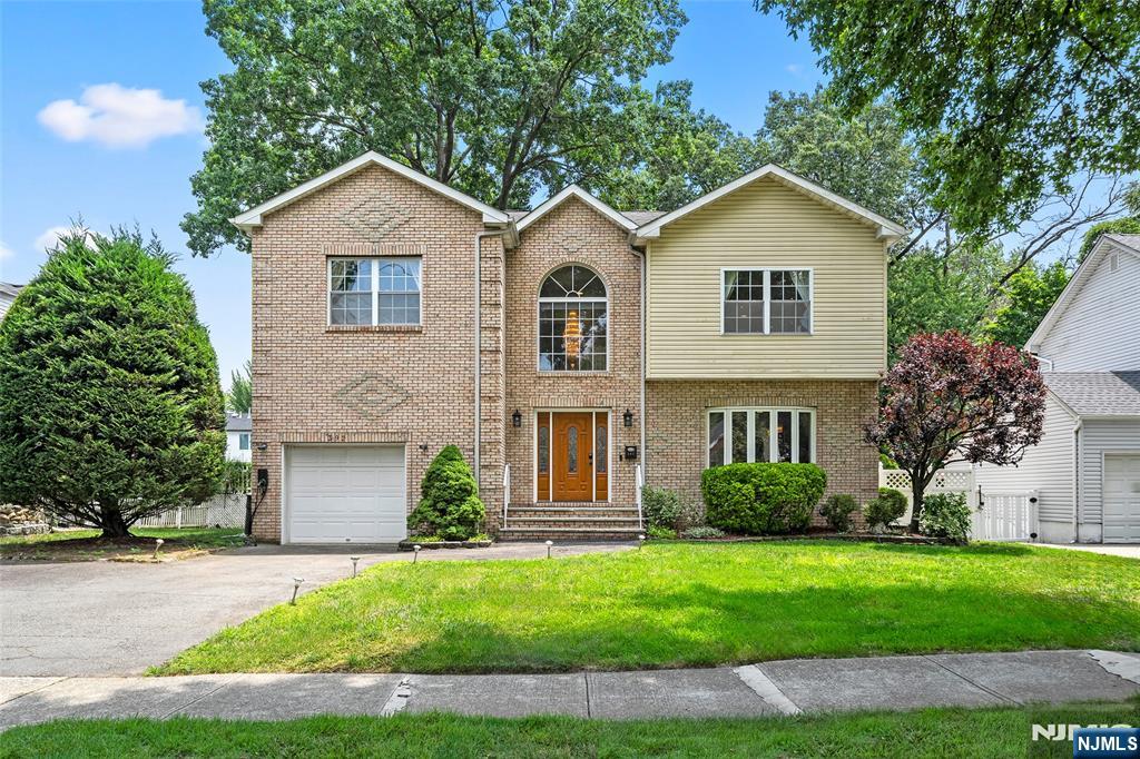 Nestled on a quiet street within the highly sought-after River Edge School District, this beautifully maintained home offers the perfect blend of comfort, style, and convenience. The main level welcomes you with a dramatic two-story foyer and features a spacious open-concept living and dining area, an inviting family room with a cozy fireplace, a full bathroom, and an updated eat-in kitchen with direct access to the backyard. Upstairs, the spacious primary suite offers two closets and a private en-suite bathroom. Three additional well-sized bedrooms, a full hallway bathroom, and a conveniently located second-floor laundry area complete the upper level. The finished basement provides abundant storage, a utility room, and versatile bonus space ideal for a home office, fitness room, recreation area, or workshop. Step outside to a fully fenced backyard featuring a deck, perfect for entertaining, outdoor dining, or simply relaxing. Additional highlights include an attached garage equipped with an EV charger. Ideally situated just moments from Van Saun County Park, shopping, dining, and major transportation, this exceptional home offers the best of suburban living with convenient access to New York City.