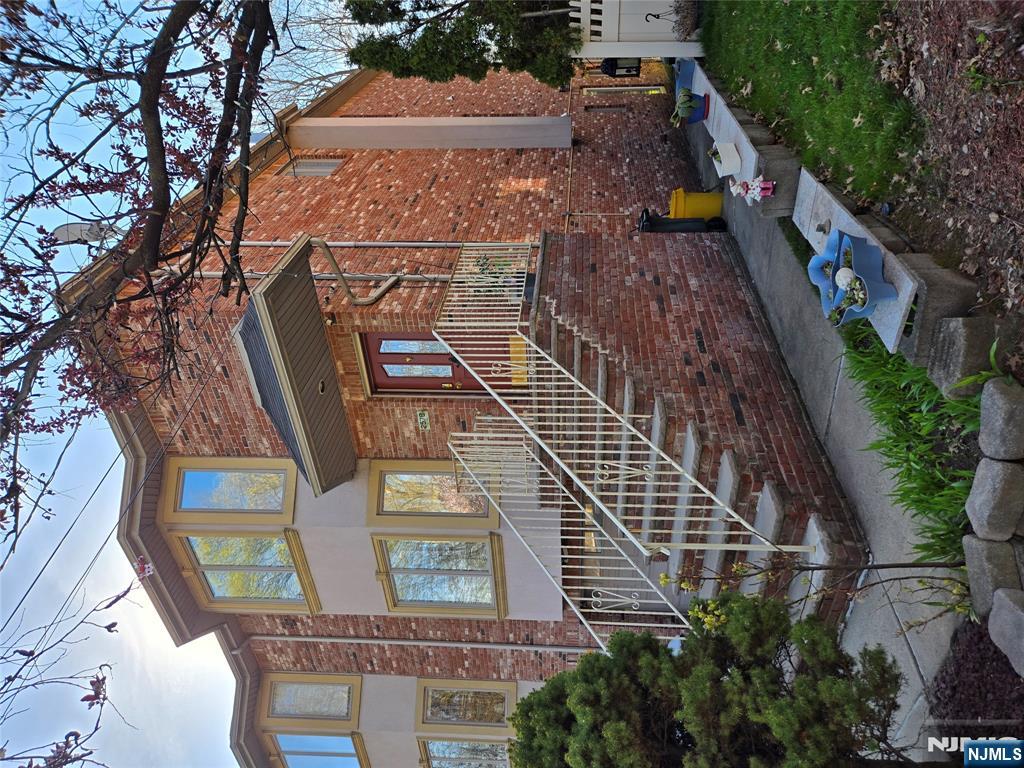 Beautifully maintained, oversized three-story duplex with an open floor plan and gleaming hardwood floors. The modern kitchen features walnut cabinetry, granite countertops, GE stainless-steel appliances, and porcelain tile flooring, with deck access for easy outdoor dining. The home offers 3.5 baths; the master bath includes both a Jacuzzi-style tub and a walk-in shower. Upgrades include R52 attic insulation, LED lighting throughout, eight security cameras, central vacuum, and custom Levolor blinds on Andersen double-pane casement windows. The fenced rear yard provides privacy. The fully finished ground level has tile floors, a private entrance, and a full bathâ€”ideal as an entertainment room, home office, or guest suite. Laundry includes an LG washer and gas dryer. Additional features: two-car garage, brick paver driveway, 50A Level 2 EV charger outlet, and plentiful on-street parking.