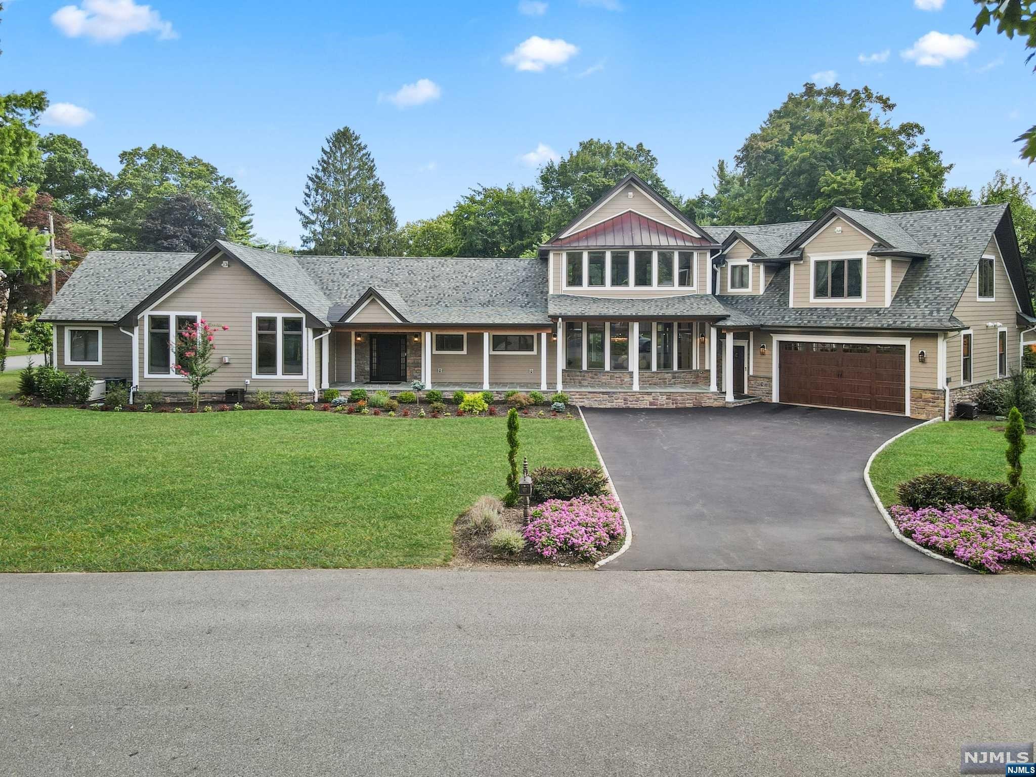Welcome to the pinnacle of elegance in this meticulously crafted 5,600 sq. ft. custom colonial home, designed for a life of opulence. Nestled in one of Bergen County's most coveted towns, this residence seamlessly combines suburban serenity with urban convenience, just a short distance from NYC. Enjoy proximity to top-tier schools, shopping & dining. Bask in a luminous ambiance with expansive windows, spacious rooms, and soaring cathedral ceilings. The gourmet kitchen boasts S/S appliances, a 15' island, and scenic views of the covered bluestone patio perfect for culinary enthusiasts. Flow effortlessly to the family room, anchored by a floor-to-ceiling stone FPL for relaxation. The primary suite offers a luxurious retreat with a chic bathroom and a custom WIC. Upstairs, find additional living space and a Jr. suite w/ a ensuite full bath & private balcony. The property, thoughtfully designed for outdoor enjoyment, invites a pool and provides ideal spaces for dining and relaxation!