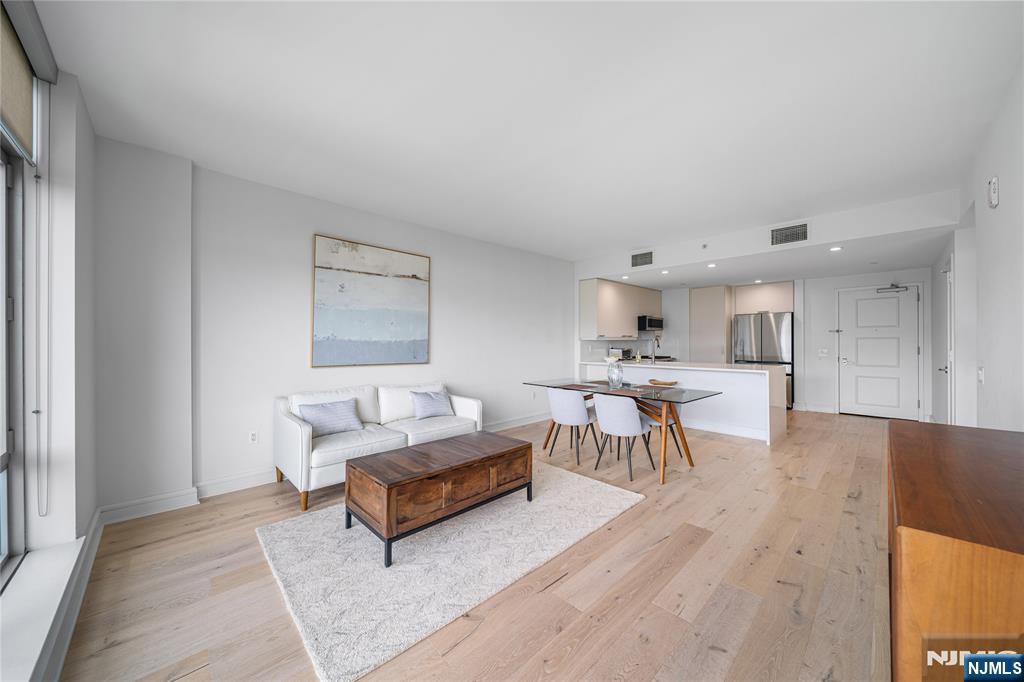 Welcome to Residence 908 at the prestigious Watermark on Hudson-where luxury meets a resort style lifestyle. This beautifully renovated 1 Bedroom, 1 Bath home is rarely available at The Watermark. It is ideally situated facing South East, showcasing unblocked views of the NYC skyline and the Hudson River. This beautifully reimagined large 908 sq ft residence, has been renovated with sleek quartz countertops, white cabinetry & integrated additional storage. Rich light toned newer wood flooring throughout, creates a sleek, clean & modern feel. Appliances are about 3 years old and include the upgrade of a Wolf stove. The large windows flood the space with natural light while perfectly framing the vistas. The furniture is included in the sale , making the property move in ready. Watermark on Hudson is renowned for its exceptional construction and 40,000 sq ft of world-class amenities. Residents enjoy both indoor & outdoor pools with hot tubs, a state-of-the-art health club with steam and sauna, valet parking, children's room, golf simulator, billiards, office, library & social room. Full service living is elevated with a 24 hr concierge and on-site management. Commuting is effortless with a private shuttle to the NY Waterway ferry and direct bus service to NYC across the street.All of this combined with low taxes, makes this home an outstanding value in one of the Gold Coast's most in demand luxury communities. Experience refined waterfront living in time for Summer.
