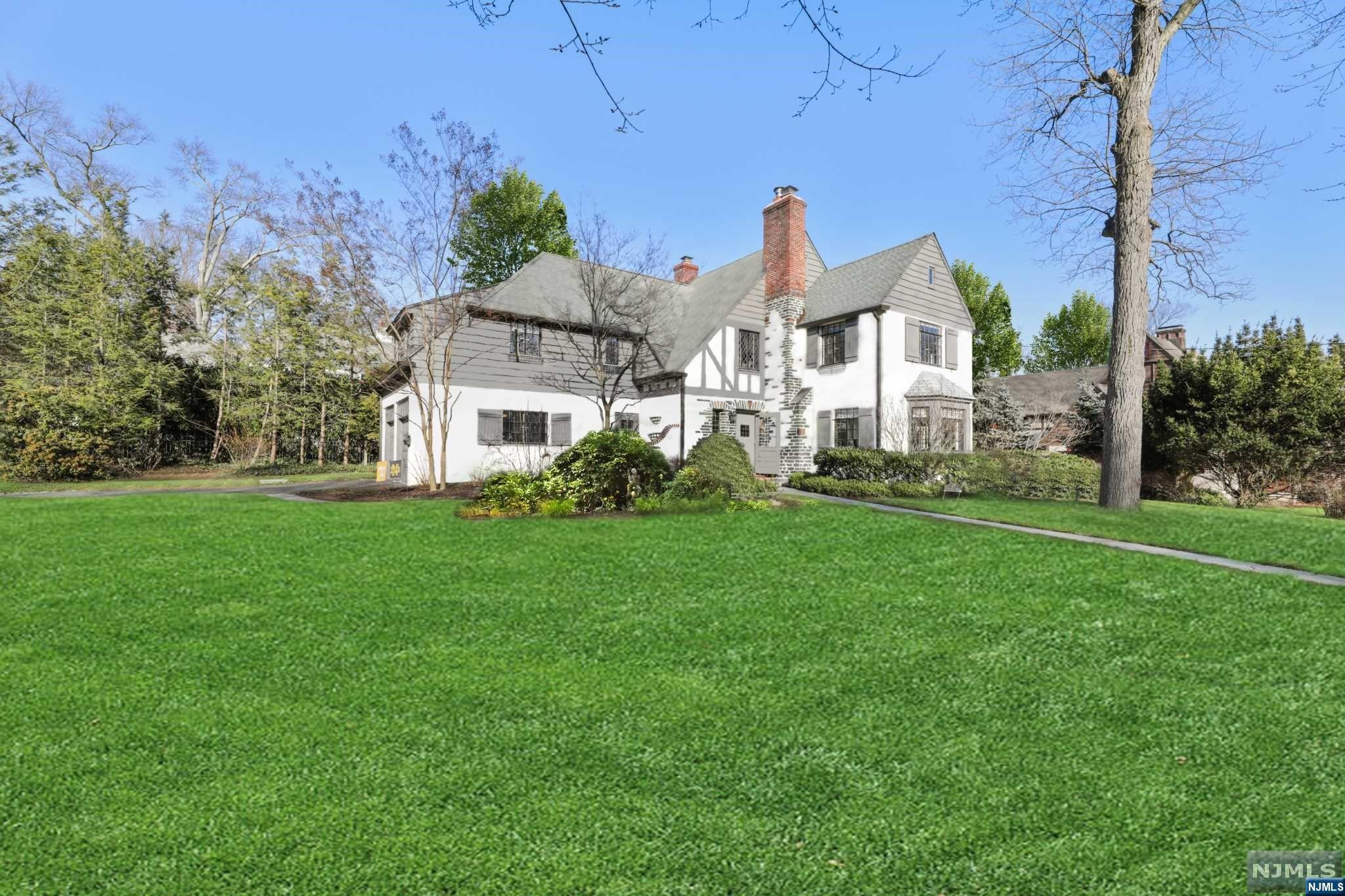 Elegance and timeless architectural treasures combined with today's modern amenities in the stellar Knollwood section of Short Hills provided in this stunning 4 Bedroom, 3 Full and 2 Half Bathroom home on a gorgeous lot and quiet street within minutes to train, town and schools. Expansive updated turn-key Tudor with open and airy floor plan. 1st floor features Gourmet Kitchen large island and built-in banquette. Family Room with vaulted beamed ceilings, limestone fireplace and private patio access. Living Room boasts a stone fireplace and bay window transitioning to Dining Room + a delightful sunroom / office. Primary Suite provides 2 huge walk-in closets and deluxe Full Bath. 2nd bedroom with spacious walk-in closet. 3rd bedroom provides direct access to hall full bath. Large Junior Suite with 3 closets and private full bath. Convenient upstairs Laundry area completes 2nd level. Lower Level includes Rec Room, a 31-foot long Game Room + Gym/Office/Guest Room with Powder Room.