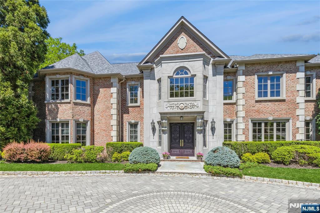 Nestled high atop the cliffs in prestigious Tammy Brook Hills, this custom built brick manor crafted with exquisite millwork and detail is designed by well known architect James Nigro. Stepping inside the grand marble foyer you're eye is immediately drawn to a magnificent 2 story formal living room with floor to ceiling windows and sweeping mountain /sunset view. The banquet sized dining room is an entertainer's dream. Grand chef kitchen expands to large eating area ,family room and outdoor terrace. Mahogany library/office, grand great room,2 ensuite bedrooms,2 powder rooms and laundry room complete the first floor. 2nd floor boasts impressive primary suite w/ tray ceilings sitting area & fireplace,2 ensuite bedrooms, 2 bedrooms with Jack & Jill bath. The walk out lower level is comprised of kitchen, gym, sauna, bedroom, full bath, theatre, rec room /game room which leads out to lush rear yard, patio & gleaming heated salt water pool. This residence is the pinnacle of elegant living.