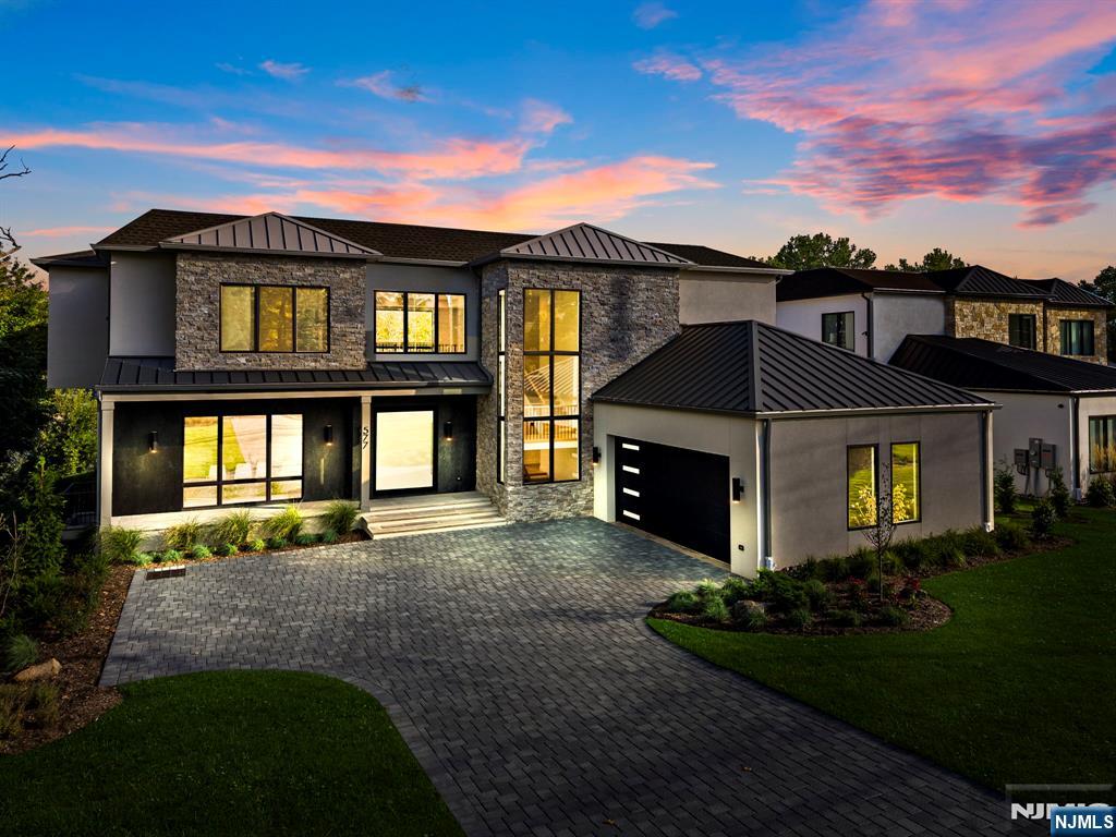 This Modern mansion is a collaboration between J Morra Management, tuaCASA design group and Zampolin Architects. This 6 bed, 6 full bath, 1 half bath, two car garage estate is situated on a 26,202 sq foot lot (0.6 acre) with the residence boasting 7,054 sq. feet of living area. The first floor starts with a grand oversized pivot door and continues to a foyer, gallery, two story great room with double sided fireplace, a chef's kitchen with commercial appliances and porcelain countertops, a separate prep kitchen and pantry with a second refrigerator and dishwasher, a breakfast area walking out to a covered patio, a library, mud hall and a guest en suite and powder room. The second floor features the primary suite with radiant heating in the master bath with 3 additional bedrooms - all en suite and walk in closets. The basement features a media room, guest room suite, gym and mechanical room. The fenced in backyard is curated for entertaining with a gunite pool and manicured lawns and a sprinkler system. Additional features include protection from whole house back up generator a central vacuum, porcelanosa vanities and tiles, wide plank white oak floors, and an additional outdoor patio surrounding the pool with 2x2 stone.