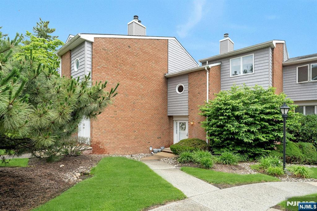 Welcome to this charming 2-bedroom, 2.5-bath townhome nestled in a quiet residential neighborhood in River Edge. Ideally situated in the interior courtyard of this beautifully maintained community, this home offers both privacy and convenience. The welcoming entry foyer features a powder room and opens to a spacious, sun-filled living room showcasing a stunning custom accent wall with a fireplace, creating a warm and inviting focal point for relaxing or entertaining. The bright eat-in kitchen features recessed lighting, a classic subway tile backsplash, and sliding glass doors leading to a private composite balconyâ€”perfect for morning coffee or outdoor dining. Upstairs, the generous primary suite offers a private full bath, while a spacious second bedroom, an additional full bath, and abundant closet space complete the second level. The lower level features a versatile office or possible third bedroom, direct access to the attached oversized garage, a laundry area, and additional storage. Ideally located near the River Edge Train Station, express bus service to NYC, Roosevelt School, restaurants, shopping, parks, and the River Edge Swim Club, this home offers exceptional convenience for commuters and everyday living. Rare opportunities like this don't come along oftenâ€”don't miss your chance to make this wonderful townhome your own. A must-see!