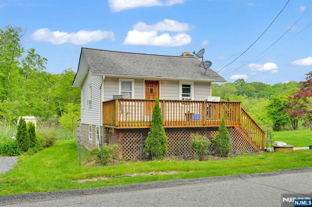 Cozy Upper Greenwood Lake Investment Property! Charming 2-Bedroom Cottage just a block from the beach and clubhouse! Enjoy the tranquil setting with a large yard backing to a stream perfect for entertaining or relaxing outdoors. Currently tenant-occupied with a 2-year lease, this property offers immediate rental income and excellent investment potential. Don't miss your chance to own a slice of lake community living schedule your showing today!
