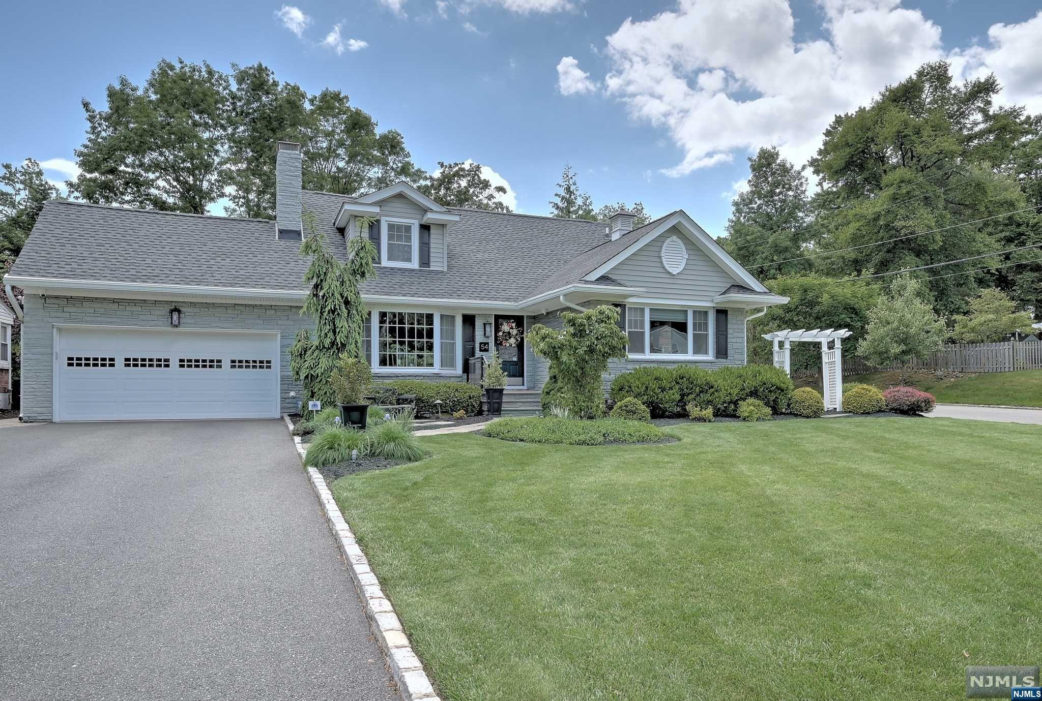 Situated on a lovely corner lot, this is luxury living at its finest! Move in ready! Designer appointed interior finishes throughout the house, this tranquil retreat is a place to call home. Totally gutted, and renovated, this home has so many beautiful features. The extra large custom kitchen island has a live edge wormy maple countertop and open wall shelving w/turnbuckle support. High end appliances, two working fireplaces, AC only 2 years old, high definition customized 5 camera surveillance system w/DVR and monitoring system, wireless central alarm system w/water/heat sensors. Brand new tankless hot water heater, gorgeous high end bathrooms. The basement is completely finished with an exercise/yoga studio, a gas fireplace to watch your favorite movie and a place to enjoy entertaining/wine by the custom wine wall cellar (400 bottle capacity). Abundance of closets/storage throughout the home. The yard is impeccably landscaped with lighting to highlight the exterior of the home.