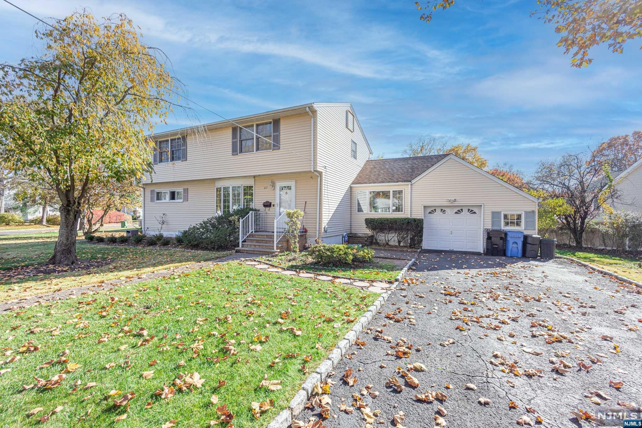 SPACIOUS EXPANDED RANCH SITS ON CORNER LOT OF SOUGHT-AFTER AREA IN TOWN. FIRST FLOOR BOASTS A LARGE LIVING ROOM WITH A BOW WINDOW,HUGE MODERN CUSTOM KITCHEN WITH ISLAND, GE PROFILE APPLIANCES, GARDEN WINDOW, SEPARATE EATING AREA, SLIDING DOORS TO AMPLE SIZE DECK WITH AWNING. FRONT TO BACK CATHEDRAL CEILING. TWO BEDROOMS AND A FULL BATHROOM. UPSTAIRS HAS CUSTOM EAT-IN KITCHEN, THREE ADDITIONAL BEDROOMS AND FULL BATHROOM. BASEMENT IS FULLY FINISHED AND HAS TWO NICE SIZE ROOMS. OTHER AMENITIES INCLUDE multi ZONE HEAT, 2 ZONE CENTRAL AIR CONDITIONING, ANDERSEN WINDOWS, 5 CEILING FANS, RECESSED LIGHTING, CUSTOM WINDOW TREATMENTS, SPRINKLERS, LUSH LANDSCAPING WITH DECORATIVE LIGHTING. A MUST SEE!