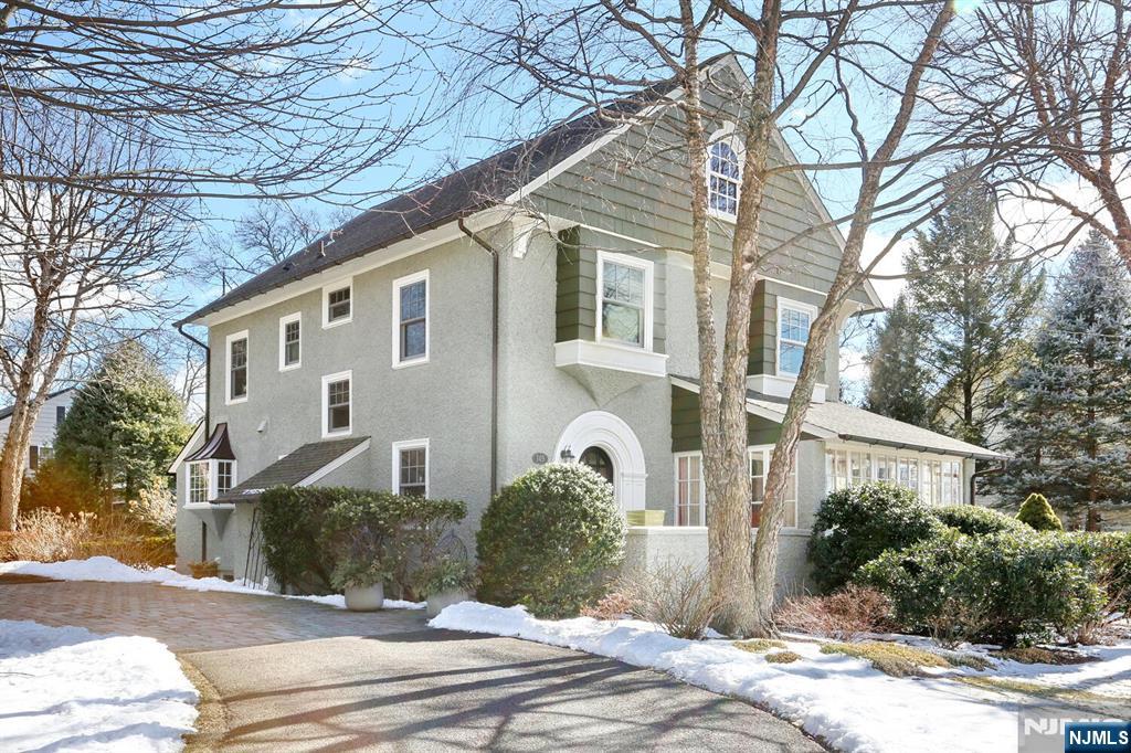 This 4 BR, 4 Bath Colonial home is located in one of the most desirable areas in Ridgewood. Classically updated with modern amenities offering luxury plus all the warmth and charm of a traditional Ridgewood Colonial. Large sunny Rooms with High Ceilings, Custom Moldings,3 Fireplaces, Marvin windows. Formal Entry Foyer, Elegant Living Room opens to the four season Sunroom.The formal Dining Rm is a show stopper. Ulrich designed Kitchen complete with Viking Range, honed marble countertops add to the charm and classic design. Casual Dining area to the gathering room with wet bar, fireplace and speakers/sonos throughout. 1st floor marble PR. The Primary suite entrance features a double entry with custom stained glass trim, large walk-in closet and FP. 2 additional bedrooms and double sink Bth complete this Floor. 3rd floor BR and full bath, bonus unfinished room with large window. Tumbled bluestone circular driveway, copper gutters, flat yard with a 2 car detached garage.A true Gem!