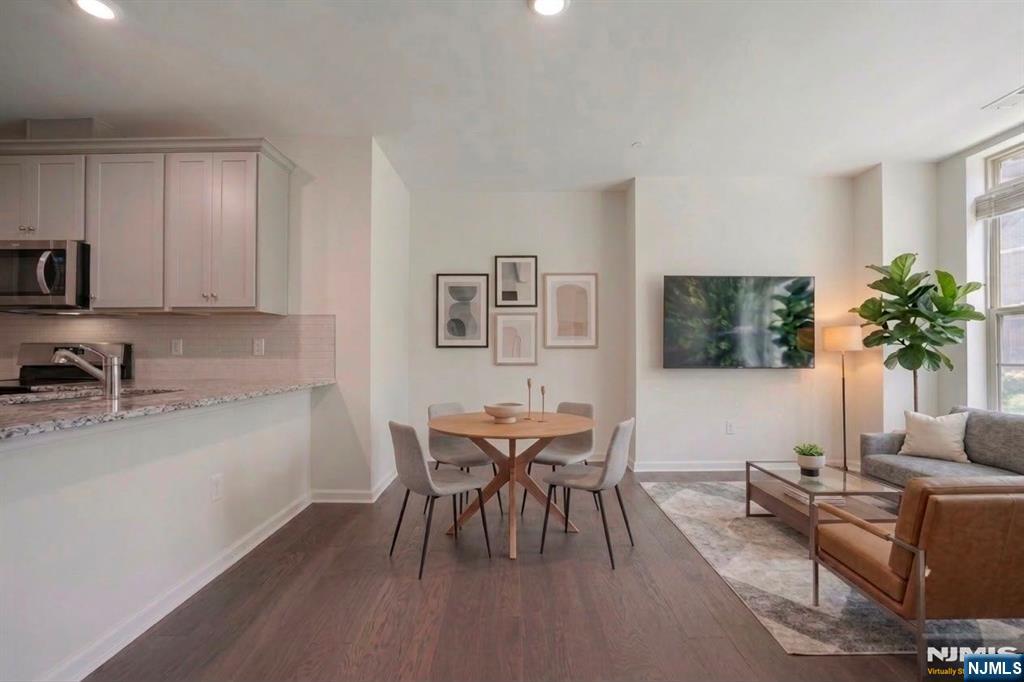 Call Mital Kataria at 732-789-0670 to schedule a tour. Your Home Search Ends Here! Experience A Convenient Lifestyle At One Of The Most Sought After Communities In Bergen County. This built 2 bed 2 bath Townhome Features a Spacious Living/Dining Area w/ Over-Sized Windows. The home built in 2022 offers tax savings with TAX ABATEMENT. With detailed and thoughtful finishes throughout, you are sure to get impressed with every space in the home. Upgraded Kitchen w/ SS Appliances, grey cabinets, granite countertop, upgraded faucet, backsplash, pantry, coat closet and much more. Head upstairs to huge Master Bedroom w/ Walk-In Closet; Master Bath w/ upgraded Modern double Vanity & Soaking Tub. The 2nd Fl also offers Bedroom #2, Washer/Dryer & Linen Closet. Attached 1 Car Garage + 1 Car Driveway. LINK @ Wesmont Station Is Conveniently Located From NJ Transit Train & Bus Stops For Easy Commute To NYC & Near All Major Roadways, Shopping, Dining. Onsite DD, Kids & Dog Park. Enjoy Luxury Of Sports Athletic Complex At Door step.