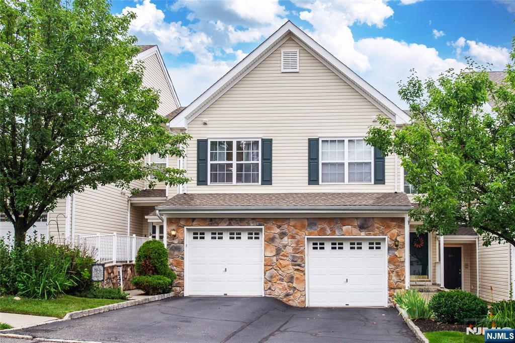 Welcome to The Highlands of Pompton Lakes! Perched in one of the community's most desirable locations, this beautifully maintained 3-story townhouse offers breathtaking panoramic views of Pompton Lakes and the surrounding mountains. This spacious home features 2 bedrooms, 3 bathrooms, an attached one-car garage, hardwood floors, a cozy gas fireplace, and updated kitchen and baths that blend style with everyday functionality. The sun-filled open-concept living and dining area is ideal for relaxing or entertaining, with expansive windows showcasing the spectacular views. The primary suite offers vaulted ceilings, a private en-suite bath with double sinks, three closets including a walk-in, and stunning mountain views. The second bedroom provides flexible space for guests, a home office, or additional living needs. The finished walk-out lower level adds valuable living space, perfect for a family room, media room, office, gym, or guest area, with direct access to the patio. Enjoy the private deck or patio while taking in the peaceful surroundings and beautiful sunsets. Residents enjoy beautifully maintained grounds, two in-ground pools, and a low-maintenance lifestyle, all within walking distance of shopping, dining, parks, public transportation, and with easy access to major highways. Combining updated finishes, exceptional views, and a prime location, this move-in-ready home offers comfort, style, and convenience. Don't miss this opportunity!