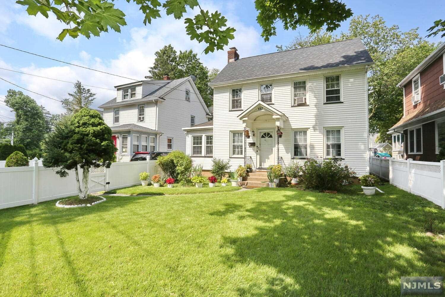Rare Find! This lovely Colonial with entrance to open floor plan of continuous rooms and features perfect for entertaining. Large Modern, eat-in kitchen with center island flows to the Large Living Room with fireplace. The openness to Large dining room offers a great flow to the kitchen. Private Den, music room or home office. Side staircase leads to 2nd floor King Sized Master Bedroom, two additional bedrooms and lovely bath. 3rd Floor Staircase leads to "2 ROOM PRIVATE GET-A-WAY". Partially Finished basement with Sound Room. This beautiful and private property is fully fenced with patio and large shed, set in a prime location. All this and Close proximity to schools, downtown, Park, NYC transit options, Tenafly Border. A lot of HOME with great potential for the Price ! One of a kind Gem.