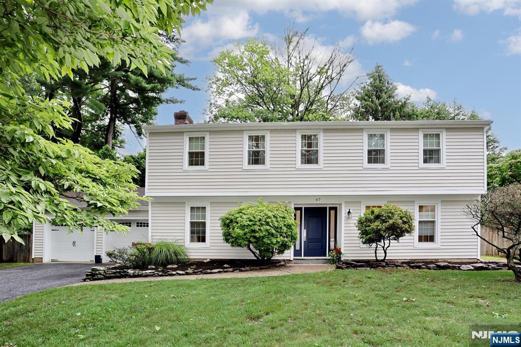 WELCOME TO THIS MOVE-IN READY GEM IN THE HEART OF HIGHLY SOUGHT AFTER HARRINGTON PARK! Just moments from schools, worship, parks, quaint downtown and transportation, this spacious light-filled 4 bedroom home features a unique multi-level layout perfect for modern living. The ground floor offers a den/office, eat-in-kitchen with new floors, bar-height peninsula, SS appliances, quartz countertops, adjacent laundry and powder room. The dining room features a floor-to-ceiling picture window and sliding glass doors to the fenced back yard for seamless indoor/outdoor living. An expansive 1st floor living room is drenched with light from the triple-bay windows overlooking the backyard. Ascend a few steps to the 2nd floor with 4 spacious bedrooms and hardwood floors throughout and primary bedroom suite. The top floor features a large Bonus Room with vaulted ceilings and abundant light and storage. 2 car garage and large drive. Top schools & perfect location! Don't miss out - this is the ONE!