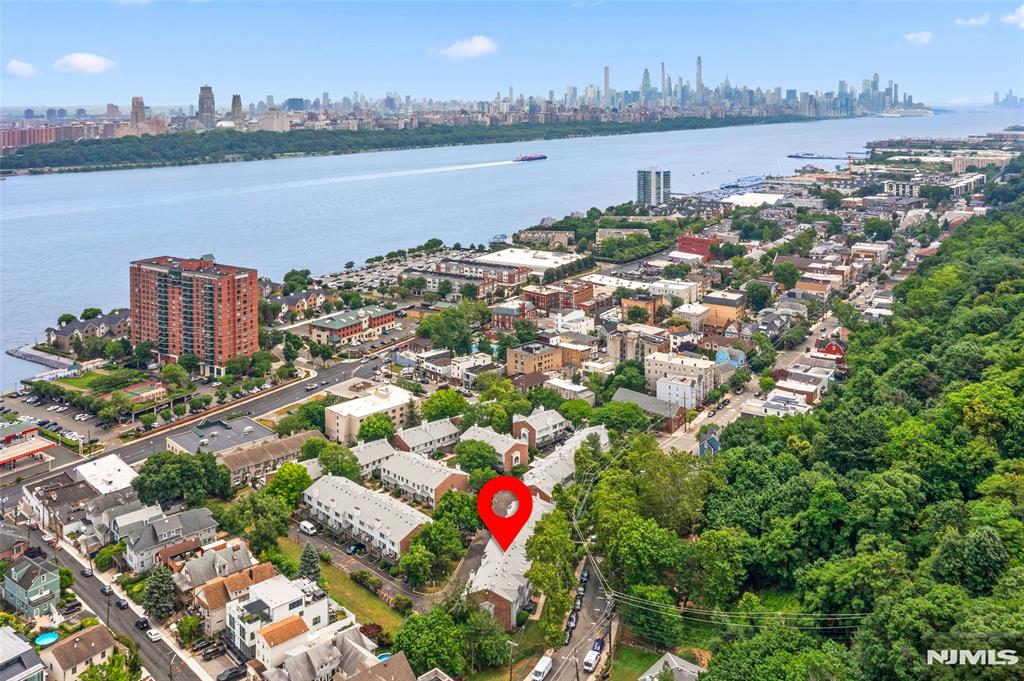Please Call/Text Rita Hsing @ 646-639-2856 for questions or showing appointment. Welcome to 477 Undercliff Avenue, a beautifully maintained 3-bedroom, 2.5-bath townhome in the desirable Panorama community of Edgewater. Freshly painted and move-in ready, this spacious residence offers an ideal blend of comfort, style, and convenience. The main level features an open and inviting layout with generous living and dining areas, perfect for everyday living and entertaining. The well-appointed kitchen provides ample cabinetry and workspace, while large windows fill the home with natural light. Upstairs, the primary suite offers a private retreat with an en-suite bath and abundant closet space, complemented by two additional bedrooms and a full bath. A two-car garage provides convenient parking and extra storage. Enjoy easy access to NYC transportation, shopping, dining, waterfront parks, and all that Edgewater has to offer. Don't miss this exceptional opportunity to own in one of Edgewater's most sought-after communities.