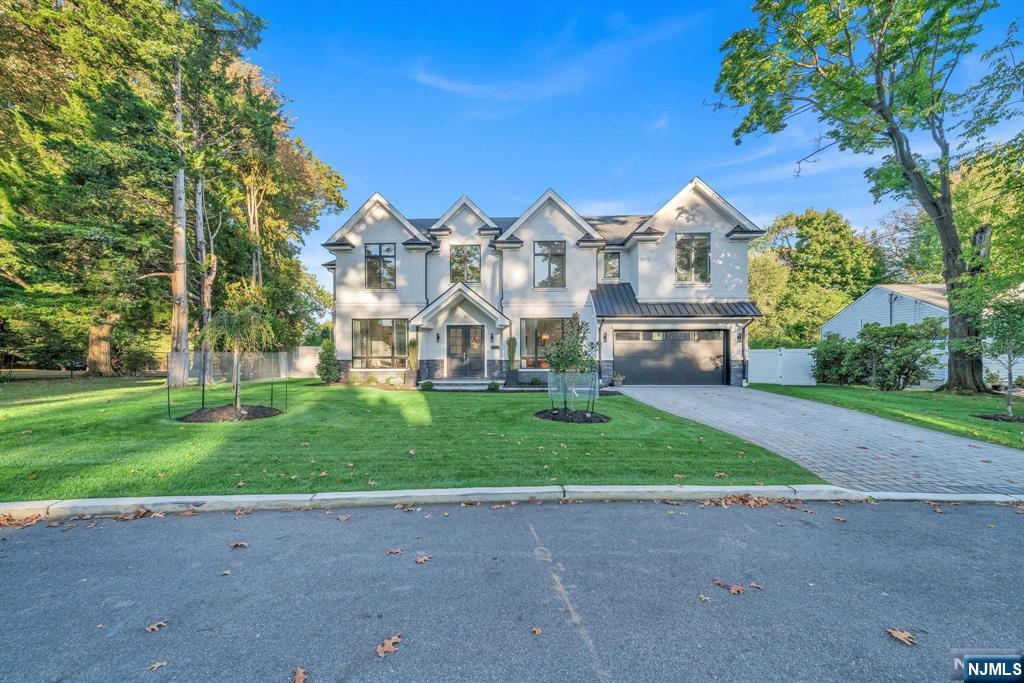 Experience luxury living in this stunning, 1 year old home designed by award-winning architect Robert Zampolin. The main level is illuminated by 10' ceilings and showcases a grand 2 story foyer that flows into an open-concept kitchen and great room, creating a perfect space for entertaining. The elegant kitchen features designer cabinetry and professional-grade WOLF and SUBZERO appliances, flowing seamlessly into the spacious great room. Boasting 6 bedrooms and 6.5 bathrooms, this home includes 4 upstairs bedrooms, each with its own en-suite, including a spectacular primary suite. Step outside to your beautiful backyard oasis with a patio and hot tub. The finished basement adds appeal with a bedroom, a bathroom featuring a steam shower, a gym, and a rec room complete with a wet bar. Situated on a quiet street, this residence offers access to blue ribbon schools, easy NYC commuting, and proximity to shopping and dining. Don't miss this blend of style, comfort, and sophistication!
