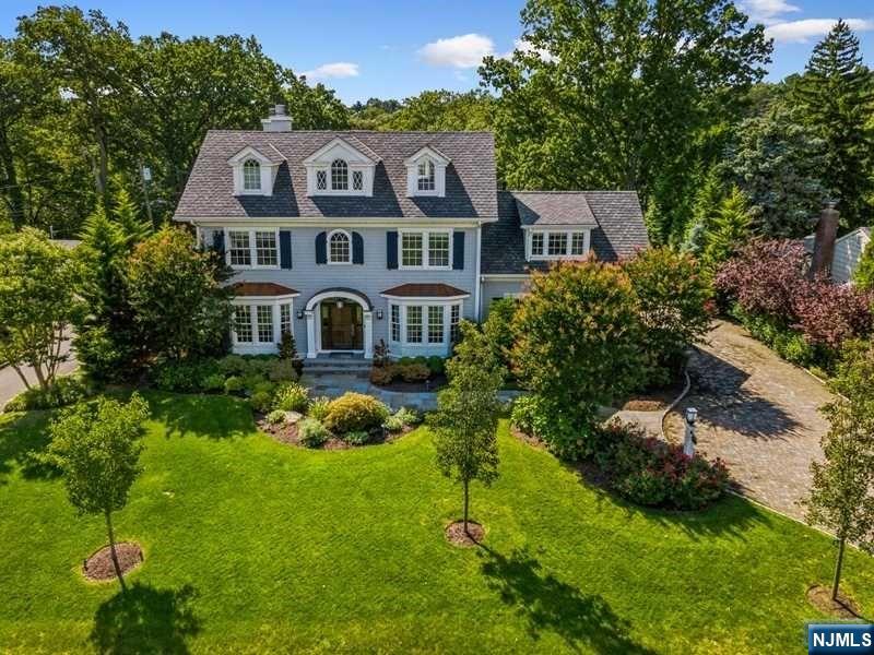 Exquisite Colonial sits atop of 11-acre picturesque Yantacaw Brook Park offering one of a kind panoramic views. Home is breathtakingly beautiful & elegant offering soaring ceiling, stunning millwork & abundance of natural light. Formal rooms include LR with wood burning fireplace & custom shelving, DR & formal powder. FR with another wood burning fireplace, sunrm & kitchen all have radiant heat & stunning panoramic views of park. Chef inspired kitchen is loaded with special features including top of the line cabinetry & appliances, coffee bar & butler's pantry equipped with 250-bottle wine cooler. Stunning Primary Suite boasts vaulted ceiling, gas fireplace, custom closets, lux marble bath & ext. deck. 3 add'l BRs, 2 with ensuites, hall BA, den & laundry complete 2nd level. Expansive 3rd flr BR suite has full bath. LL offers huge media/game rm, spectacular gym, full BA, BR & plenty of storage. Lush backyard has great views of the park. Finished 2-car garage with epoxy floor.