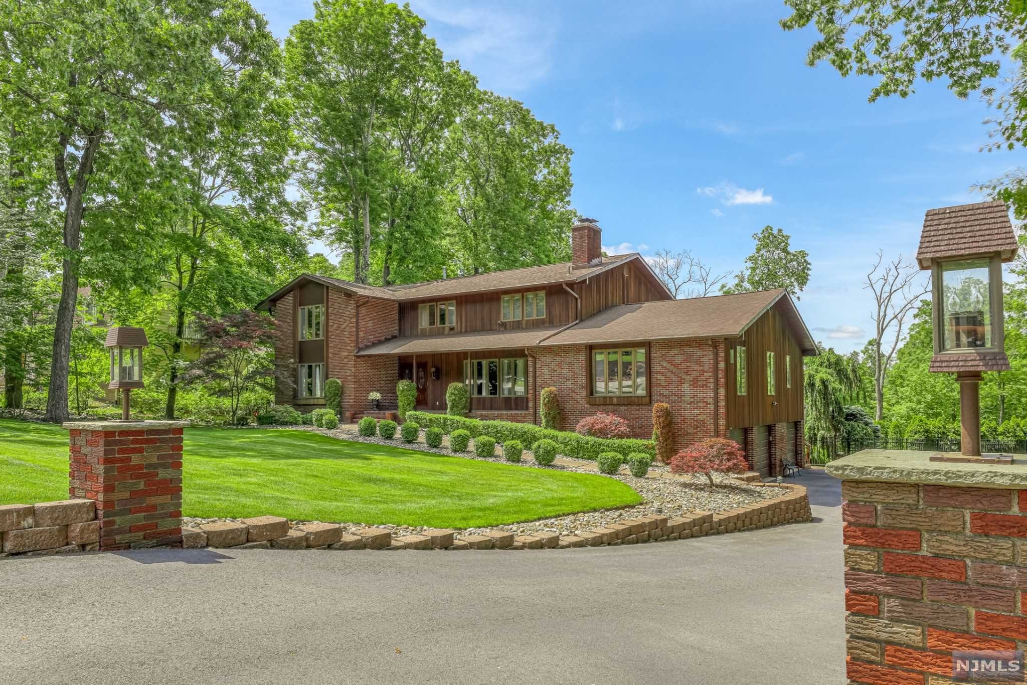 Welcome to this spacious, well-kept, 6-bed, 5.1-bath custom home located in Indian Hills - one of Wayne NJ's most coveted locations, on the periphery of the Pines Lake community! This home offers endless options to relax & entertain, w/multi-room views of over an acre of property, a private backyard oasis featuring an Anthony & Sylvan gunite pool, cabana, and plentiful seating between the pool area, patio, and decks. Custom kitchen with expansive island, high-end appliances, and abundant pantry space. Family room with cathedral ceiling & wood-burning fireplace. Living room w/wood-burning fireplace, dining room, piano room, sitting room, bedroom/office, and 1.5 baths finish off the 1st floor. Upstairs is the primary suite w/cathedral ceiling, walk-in closet, large bath w/dual vanity, glass & tile shower & tub, + 4 more bedrooms + 2 full baths. Finished walkout basement with rec space, bar, exercise area, and full bath. 3-car garage + oversized drive. 22-kW generator (2020) + more!
