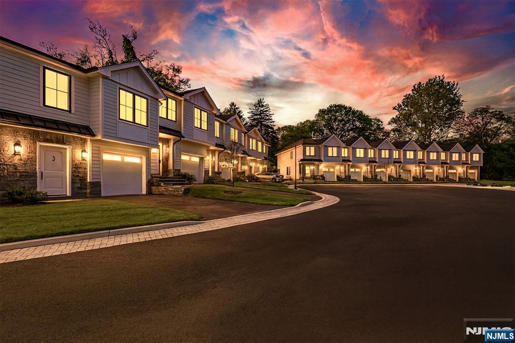 Luxury new construction interior townhome unit at Liger Estates, offering modern finishes and everyday comfort in the sought after town of Oradell. Built by Rock Solid Builders, this residence features 3 bedrooms, 2 full baths, and 2 half baths, with high ceilings creating an open and functional layout throughout. Open concept living with the kitchen featuring custom cabinetry, stainless steel appliances, quartz countertops, and sliding glass doors leading to a patio and backyard. The primary suite includes two custom walk-in closets and a bathroom with a soaking tub, oversized shower, and double vanity. Two additional bedrooms share a full bathroom, with a conveniently located laundry area on the same level. A fully finished lower level provides additional living space, complete with a recreation room and half bath, perfect for entertaining, a home office, or a gym. Enjoy outdoor living with a serene patio and professionally landscaped surroundings that complement the home's modern architecture. Conveniently located near top-rated schools, dining, shopping, and transportation, this luxury townhome delivers refined living with exceptional convenience.