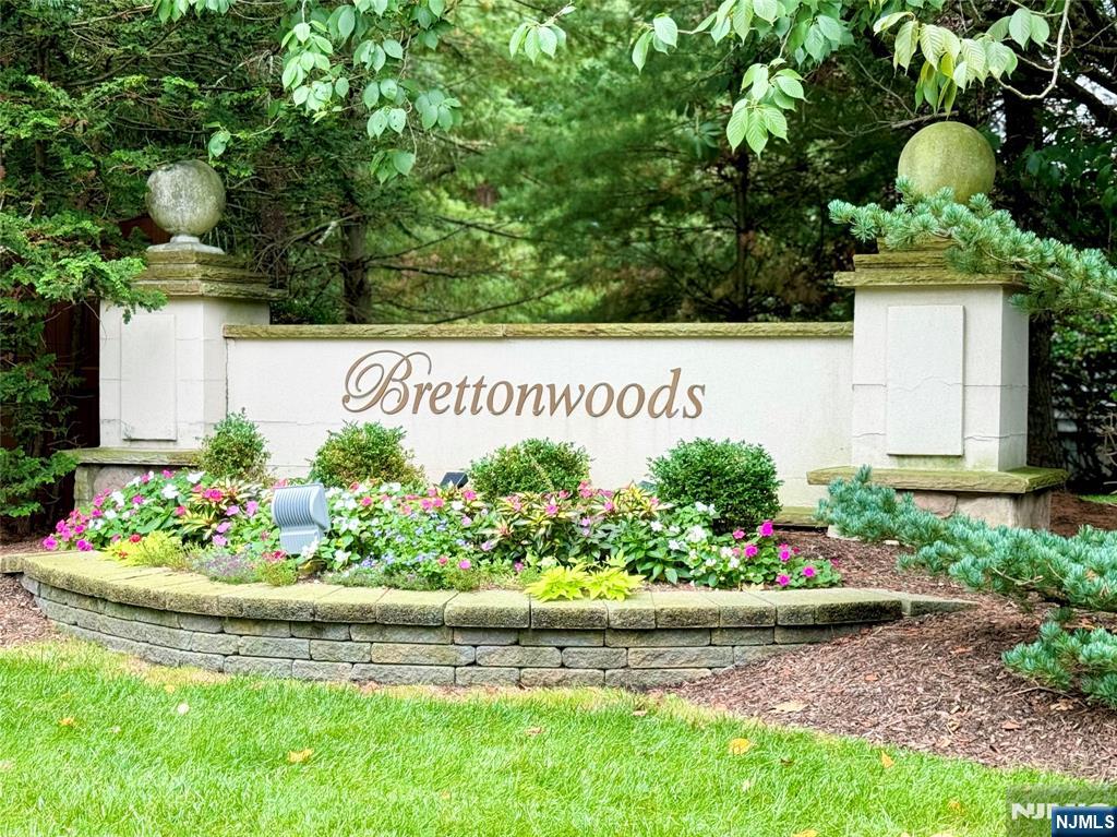 Don't miss this stunning townhome in the sought after Brettonwoods community in Paramus. This spacious & sun-lit Deerfield model has approx 2308 square ft, not including the full finished basement & attached 2 car garage. This desirable home features an elegant entrance foyer, designer kitchen w/cherry cabinets, granite countertops & a breakfast bar. Open concept to the great room w/sloping ceiling & gas fireplace w/a slider to the fabulous deck & yard area, formal living room, formal dining room & powder room. Master bedroom suite w/tray ceiling, WIC, master bath w/whirlpool, bright loft area, 2 spacious bedrooms w/a Jack & Jill Bath. Full finished basement has a full bath, rec room & office. Quality workmanship w/distinctive trim, abundance of closets, alarm, beautiful hardwood floors throughout,.Energy efficient unit.Premier location that's close to public transportation, shopping, major highways, highly ranked schools & only minutes to NYC.