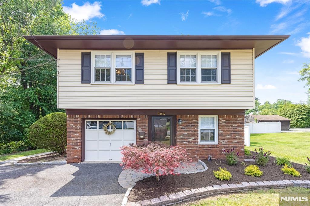 Opportunity knocks- Welcome to this bright & light raised ranch built in 1974- well maintained. Main floor features Large entry foyer w/ new flooring. Enormous Family Room w sliding glass door to patio/backyard that has a true sense of privacy, 4th bedroom/office, renovated full bath (2011), utility room, laundry room & garage. Upper level features a Large LR & FDR, EIK w/ all new SS appliances (2026), 3 good size bedrooms -all hardwood floors, full bath, new heating system & water heater (2025), interior & exterior freshly painted (2026) new storm door/shutters (2026) Patio/exterior power washed (2026), new window treatments thru-out, new landscaping/planting 2026, new fixtures. A/C -2016, Window & roof -2007, Walk to all NY transportation (Train, local/express bus) Incredible opportunity to live & raise a family in this beautiful Bergen County town.