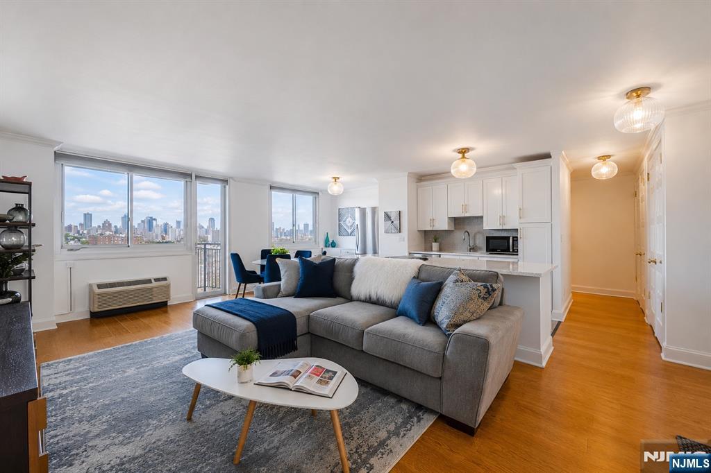 Welcome to Unit 708 at The Doric, a beautifully renovated 2-bedroom, 2-bath residence with a private terrace showcasing breathtaking, unobstructed views of the New York City skyline and Hudson River. Move-in ready, this home features bamboo hardwood floors, quartz countertops, crown molding, new interior doors, and seven spacious closets for exceptional storage. The open-concept layout seamlessly connects the kitchen, living, and dining areas, creating an ideal space for everyday living and entertaining while maximizing the stunning views. The Doric offers an impressive collection of full-service amenities, including a 24-hour doorman, outdoor pool, fitness center, community room, package room, on-site laundry, deli, dry cleaner, and daycare. Commuting is effortless with NJ Transit buses, including the #119 Express to Port Authority, right outside the building, plus easy access to the Hudson-Bergen Light Rail, Hoboken PATH, and a complimentary weekday morning shuttle to the PATH. Monthly maintenance includes property taxes and all utilitiesâ€”electric, heat, air conditioning, water, and hot waterâ€”providing outstanding value and predictable monthly costs. Verizon Fios and Optimum are available, and on-site parking is offered for an additional monthly fee.