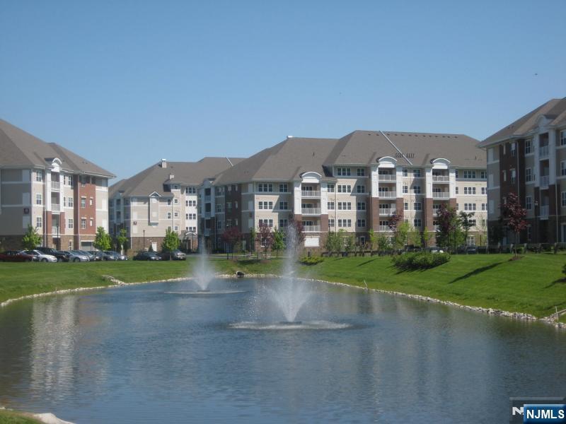 Welcome to Wanaque Reserve- 55 and better, active adult community. Wonderful Colfax model located in desirable Building 7, located next to the impressive clubhouse, featuring an impressive private balcony with views of the woods and community grounds. Beautiful layout with 1,768 sq ft, 2 bedrooms and 2 full baths. Home features: an inviting foyer leading to a formal living and dining room, an eat-in kitchen with ample cabinets, a pantry and laundry room, a den/library, and a primary bedroom with a tray ceiling, walk-in closet and a full private bath. Second bedroom has an adjacent full bathroom for convenience. Additional attributes: recessed lighting, lots of closets, custom moldings, hardwood floors, 1 car garage interior parking space, and a private balcony with perfect views of the woods. Live life to the fullest at the Wanaque Reserve with a 20,000-square-foot clubhouse with indoor & outdoor pools, a clubhouse, gym, billiards, art room, theater, tennis, 40 clubs and much more! Close to restaurants, shopping, Bergen County, and major highways.