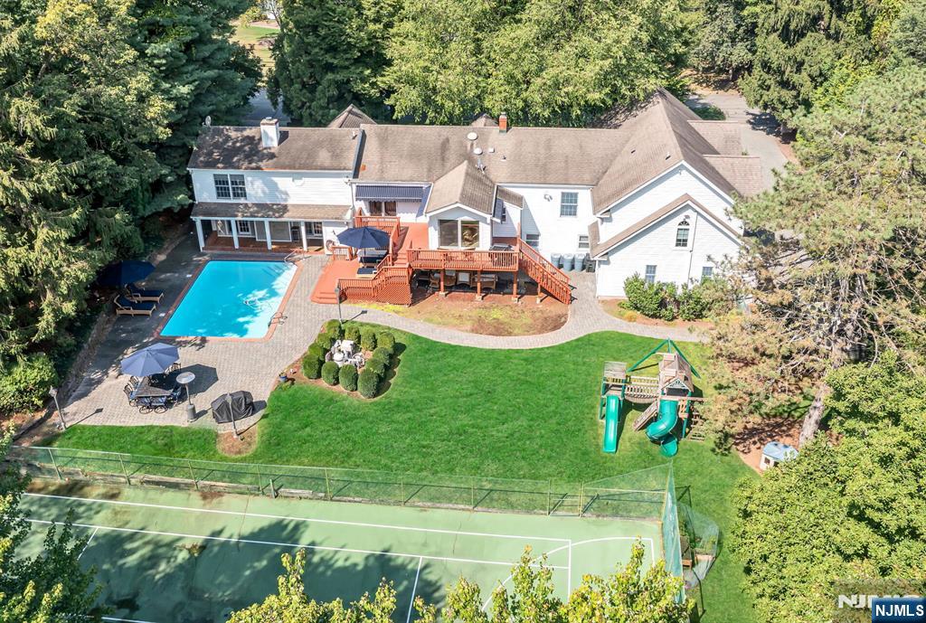 Welcome to this elegant 5-bedroom, 4-full & 3-half bathroom home, perfectly situated on a private 1.04-acre lot on a cul-de-sac.. With 5,347 square feet of living space, this residence seamlessly combines luxury with comfort. The heart of the home is a beautifully renovated kitchen, with incredible views of the pool and tennis court. The formal dining room offers a sophisticated setting for entertaining. Relax in the media/den area, which features a stylish bar perfect for hosting guests. The primary suite offers a luxurious retreat, complete with two spacious walk-in closets and an updated shower. Three of the additional bedrooms are en-suites, providing convenience and privacy, while another room can be used as a bedroom or a home office. Outside, enjoy a private pool and tennis/pickleball court, offering a private oasis with ample opportunities for leisure and recreation. The serene setting is enhanced by the amenities and the attached four-car heated garage. Experience comfortable and elegant living in this distinguished Mahwah home, right on the boarder of Allendale.