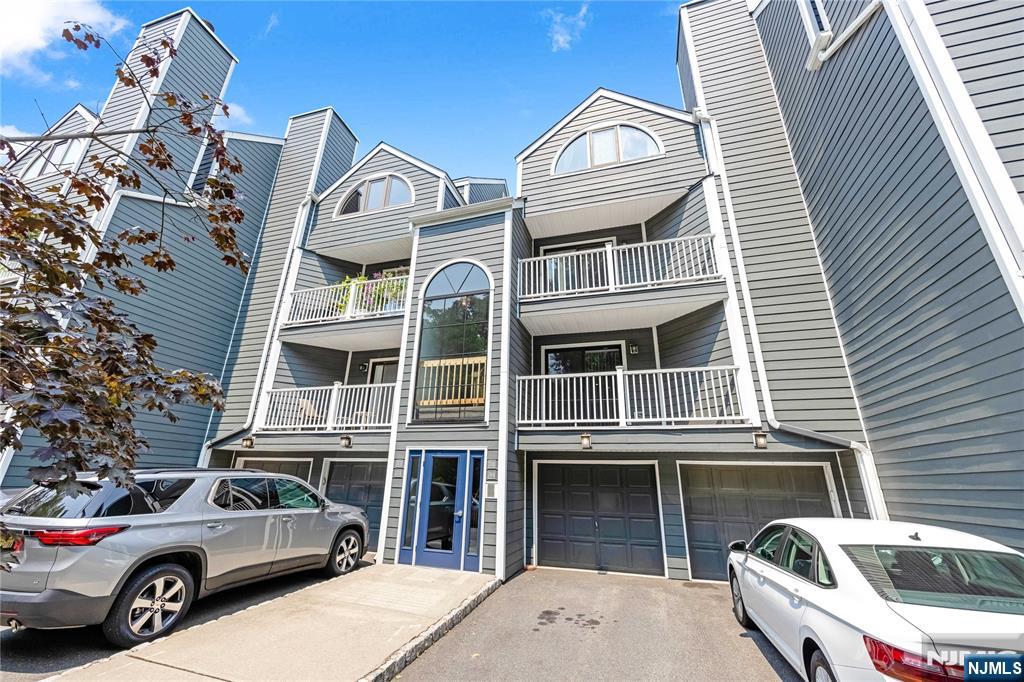 A must-see this spacious two-level A-style townhome featuring 2 bedrooms and 2 full bathrooms, with low HOA fees and low property taxes. The open-concept main level offers an eat-in kitchen, dining area, and living room with a gas fireplace, plus a bedroom and full bath. Sliding doors lead to a private terrace, perfect for relaxing. The lower level features a bright primary suite with a walk-in closet and en-suite bath, along with a nearby laundry area and an attached 1-car garage. Located on a quiet cul-de-sac in the desirable Carlton Hill community, just minutes from downtown Rutherford, shopping, parks, schools, houses of worship, public transportation, MetLife Stadium, and the American Dream Mall. Move right in and enjoy the updated bathrooms, or personalize the home to suit your style. A wonderful opportunity not to be missed.