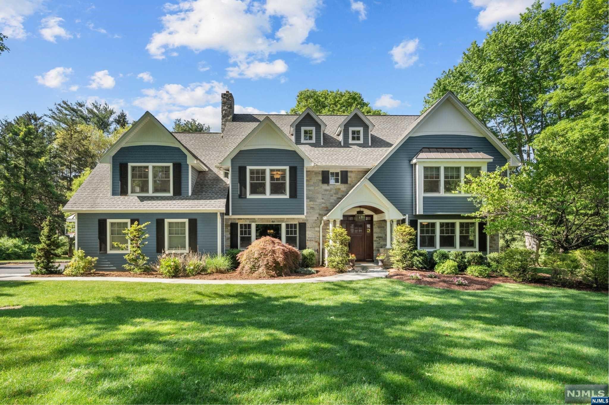Pristine Center Hall Colonial custom-built in 2012 on nearly an acre of picturesque grounds. This exceptional 5 bedroom, 4.5 bath offers 6,400 SF of unsurpassed quality, style and curb appeal. Spectacular flow throughout the light & bright 1st level with hardwood floors, volume ceilings, and an open layout between a family room & modern eat-in kitchen w/ stainless steel appliances & sizable center island. Layout starts with an entry foyer flanked by a living room and formal dining room with flow via butler pantry into kitchen overlooking family room w/ fireplace, 30-ft ceiling & doors to large blue stone patio perfect for entertaining with a wood burning fireplace & grill. Home office/bedroom & full bath, and mudroom with access to 3-car garage wrap up the 1st floor. All 4 bedrooms on the 2nd level have 10-ft ceilings, including primary suite w/ 3 walk-in closets and spa-like bath. Large finished basement with gym & step-down to a 9-ft ceiling rec room. Simply perfect!