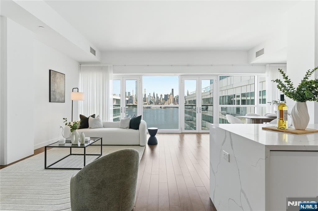 Enjoy waterfront living at its finest in Residence #1010 at AVORA â€” a spacious 1504-sq-ft home showcasing sweeping east-facing Hudson River views and refined modern finishes throughout. This thoughtfully designed residence features wood flooring, quartz countertops, contemporary cabinetry, and premium stainless steel appliances. The primary bath offers a spa-like experience with an oversized soaking tub and high-end fixtures. Enjoy AVORAâ€™s full suite of luxury amenities, including 24-hour concierge, fitness center, sports simulator, multiple resident lounges, and a stunning designed pool deck with grilling areas. Conveniently located just steps from the ferry, light rail, and NJ Transit, providing an easy commute to Manhattan. Unit comes with 2 parking spaces and a storage unit!