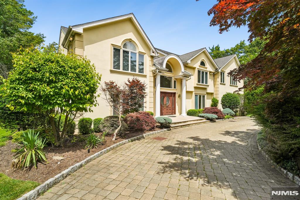 Situated on an approximately 40,380 SF lot in Cresskill, this expanded Colonial offers nearly 6,500 SF of living space with 6 bedrooms, 6 full baths, and 1 half bath. Designed for flexible living, the layout includes a first-floor bedroom and full bath, private office, formal living room, dining room, great room with a fireplace, and eat-in kitchen with granite countertops. Upstairs features multiple ensuite bedrooms, additional bedrooms connected by a Jack-and-Jill bath, an additional full bath, and a dedicated laundry room. The fully finished walkout lower level includes a second full kitchen, large recreation and entertainment area, full bath, and covered patio. Additional features include hardwood floors, central air, baseboard gas heat, a 3-car attached garage, a circular driveway, and parking for multiple vehicles. The private backyard includes a large deck, covered patio, and an in-ground pool currently covered and ready for future restoration. Located near downtown Cresskill's restaurants, cafes, shopping, parks, and everyday conveniences, with access to commuter bus service to the Port Authority Bus Terminal in Midtown Manhattan. Offering exceptional space, a desirable location, and tremendous potential, this home presents an opportunity for the next owner to update, personalize, and create lasting memories while making it their own. A rare offering on one of Cresskill's premier residential streets.