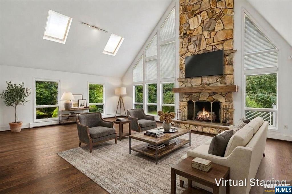 Nearly 6,500 SF on approximately .93 acres. Expansive outdoor terrace, covered patio & in-ground pool. Two-story great room with stone fireplace. Situated on one of Cresskill's premier residential streets, this expanded Colonial offers 6 bedrooms, 6 full baths and 1 half bath with a layout designed for flexible living and entertaining. A dramatic double-height foyer welcomes you to formal living and dining rooms, a private office, first-floor bedroom with full bath, and a two-story great room featuring vaulted ceilings, skylights, floor-to-ceiling windows and a striking stone fireplace. The renovated eat-in kitchen includes a large center island, granite countertops, double wall ovens, built-in refrigerator, abundant cabinetry and direct access to the expansive rear terrace. Upstairs are multiple ensuite bedrooms, a spacious primary suite with a spa-style bath and soaking tub, additional bedrooms connected by a Jack-and-Jill bath, an additional full bath and a dedicated laundry room. The finished walk-out lower level includes a second full kitchen, oversized recreation and entertainment area, full bath and access to the covered patio and backyard. Additional features include hardwood floors, central air, high ceilings in the basement, a 3-car attached garage, circular paver driveway, mature landscaping and multiple indoor and outdoor spaces for gatherings. Convenient to downtown Cresskill restaurants, cafÃ©s, parks, shopping and commuter bus service to Midtown Manhattan.