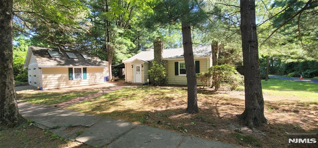 This Charming Cottage retains all of its 1930s charm with modern touches. The setting is vacation like & peaceful. Home has Central A/C & Gas Heating, including in the detached 2 Car Garage which is finished into an additional living space with 1/2bath, laundry, skylights, vaulted ceilings, windows, & Bamboo Flooring. Main house has beautiful HW Floors, Fireplace, Modern Kitchen, Great Room with rounded ceiling, Central Alarm System, (both house & Garage) many windows, & French Doors out to the deck, brick patio, and walkways. Freshly painted and waiting for your finishing touch. Great for downsizing or condo alternative. This is a must see property, both inside and out. Property has potential for expansion, remodel, or new build. Come and see, you won't be disappointed.