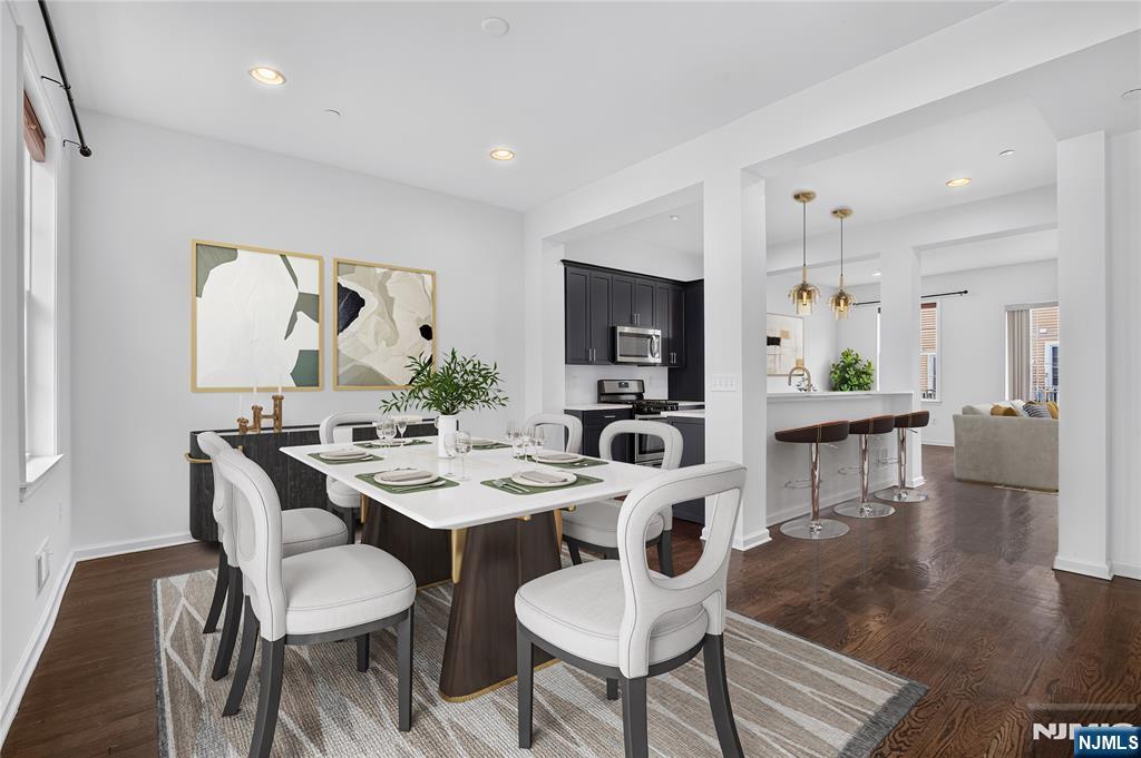 ***Call Charmy Morzaria at 609.619.2198 to see this home***An exceptional Colonial-style townhome in the highly desirable Wright Place community of Wood-Ridge. Built JUST 4 YEARS Ago, this move-in ready home offers modern finishes, spacious living, and the added benefit of a remaining tax abatement. Located just approx 30 minutes from Manhattan, you'll enjoy easy access to major highways, NJ Transit train service at 5 mins stroll, and nearby bus routes to NYC. Beautifully landscaped entrance leads into a thoughtfully designed floor plan featuring front and rear entrances, a 2-car garage, and 2-car driveway. 1st level offers a bedroom with full bath, closet space, and direct garage access;ideal for guests/extended living/home office. The main level showcases an open-concept layout with 10-foot ceilings, oversized windows, hardwood flooring, and abundant natural light. The kitchen has quartz countertops, SS appliances, pantry, breakfast bar, and flows seamlessly into the spacious dining and living areas with access to a private deck. Upstairs you'll find a spacious primary suite with dual closets, private bath, 2 additional bedrooms, a full bath, and a convenient laundry room. Home has dual-zone heating/cooling, beautiful community courtyards, a location just moments from HIGHLY Rated Catherine E. Doyle Elementary School, parks, restaurants, shopping, and the Wood-Ridge train station. An opportunity to own a newer home offering space, convenience, and excellent commuter access.