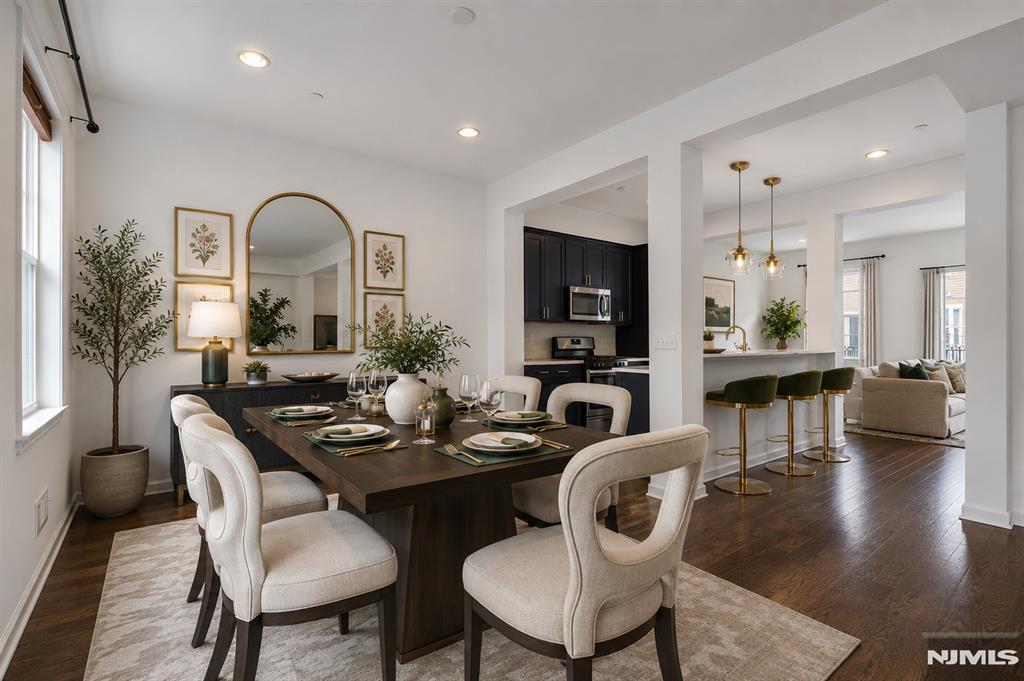 ***Call Charmy Morzaria at 609.619.2198 to see this home***An exceptional Colonial-style townhome in the highly desirable Wright Place community of Wood-Ridge. Built JUST 4 YEARS Ago, this move-in ready home offers modern finishes, spacious living, and the added benefit of a remaining tax abatement. Located just approx 30 minutes from Manhattan, you'll enjoy easy access to major highways, NJ Transit train service at 5 mins stroll, and nearby bus routes to NYC. Beautifully landscaped entrance leads into a thoughtfully designed floor plan featuring front and rear entrances, a 2-car garage, and 2-car driveway. 1st level offers a bedroom with full bath, closet space, and direct garage access;ideal for guests/extended living/home office. The main level showcases an open-concept layout with 10-foot ceilings, oversized windows, hardwood flooring, and abundant natural light. The kitchen has quartz countertops, SS appliances, pantry, breakfast bar, and flows seamlessly into the spacious dining and living areas with access to a private deck. Upstairs you'll find a spacious primary suite with dual closets, private bath, 2 additional bedrooms, a full bath, and a convenient laundry room. Home has dual-zone heating/cooling, beautiful community courtyards, a location just moments from HIGHLY Rated Catherine E. Doyle Elementary School, parks, restaurants, shopping, and the Wood-Ridge train station. An opportunity to own a newer home offering space, convenience, and excellent commuter access.