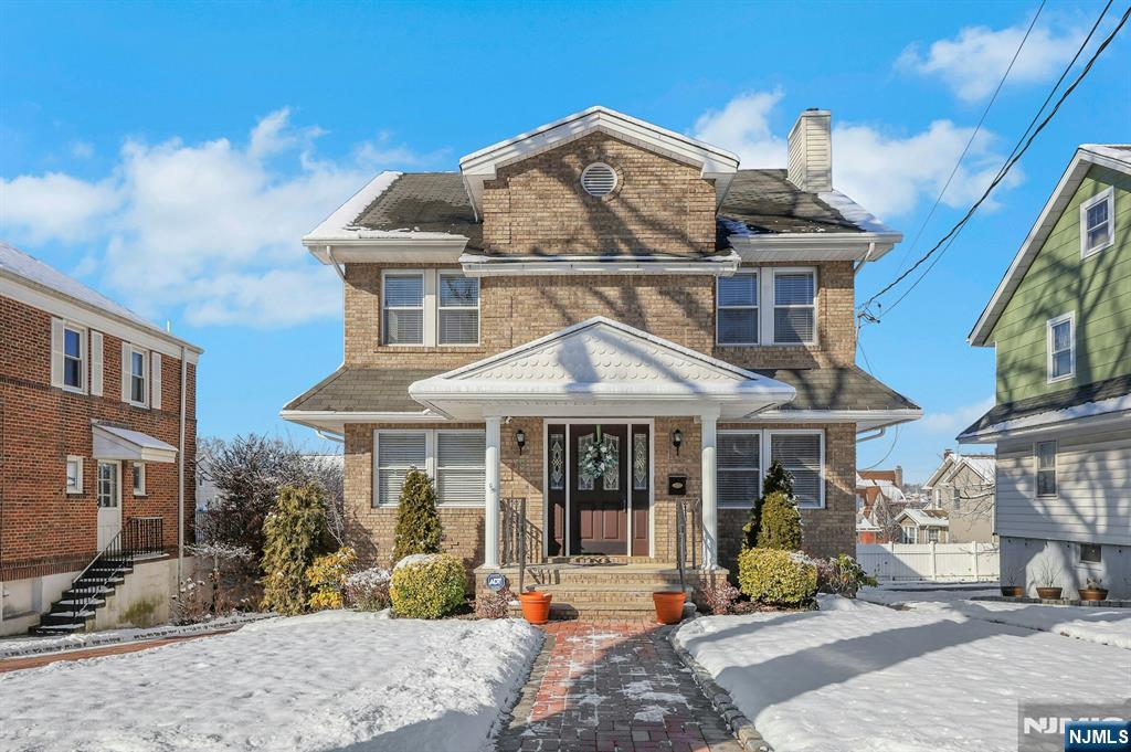 Lovely East-facing 5-bedroom, 3.5 bath, brickface colonial with built-in garage and driveway in the Manor section of town. 1st floor has high ceilings, foyer, large living room with wood burning fireplace, formal dining room, modern kitchen with granite countertop and backsplash, 1 bedroom or den, and full bath. The 2nd floor has 4 bedrooms and 2 full baths, which includes a Master Bedroom with a full bath and walk in closet. Pull down stairs to storage. 2-zone gas forced hot air heating and central air system. Fully finished basement with recreation room, summer kitchen, half bath, laundry & utility room. Numerous updates throughout the years, such as refinished floors, thermopane tilt windows, tiled bathrooms. 5 blocks to NYC bus and steps away from Manor Park!