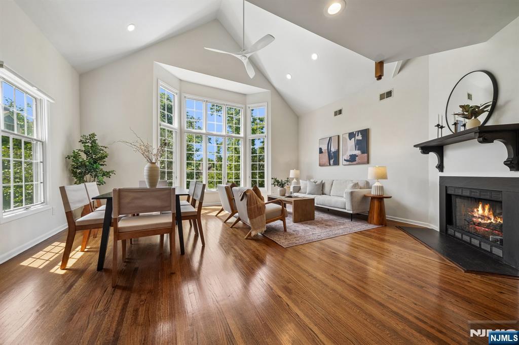 Sophisticated and spacious, this exceptional 3-bedroom, 2.5-bath townhouse offers the comfort of a primary suite on the main level combined with the ease of low-maintenance living. The beautifully renovated primary bath features dual vanities, a luxurious soaking tub, and a separate stall shower. Gorgeous hardwood floors flow throughout the home, while the dramatic cathedral-ceiling living and dining room with gas fireplace is flooded with natural light from an impressive wall of windows, complete with motorized Hunter Douglas shades. The well-appointed kitchen features granite countertops, stainless steel appliances and a sunny breakfast area for casual dining. Upstairs features 2 bedrooms, a hall bath and a versatile loft overlooking the main living space providing the perfect setting for a home office, reading nook, or flex space. The expansive lower-level family room offers additional living and entertaining space with direct access to the outdoors as well as the attached two-car garage. Ideally located near High Mountain Preserve, highly rated schools, shopping, dining, NYC transportation, and major highways, this turnkey home offers an outstanding combination of comfort, convenience, and style. This is one not to be missed!
