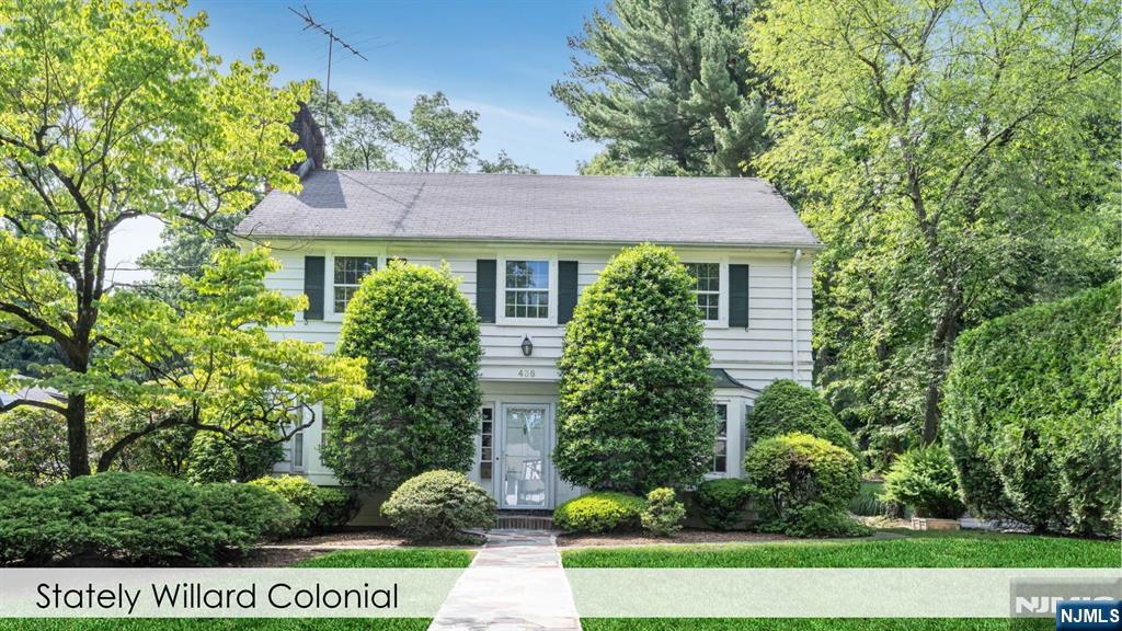 This quintessential Willard Center Hall Colonial offers the perfect blend of time-less character and exceptional living space. Featuring 3 spacious bedrooms and 2.5 baths, the home opens to a gracious entry foyer and beautiful center staircase. The first floor offers an elegant large living room and a cozy wood-burning fireplace. A bright den/office that overlooks the beautiful back yard and access outdoors. The formal dining room with classic wainscoting and bay window is perfect for holidays and evening dinners. The eat-in kitchen overlooks the backyard and connects to the expansive deck. Upstairs the oversized primary suite offers a peaceful retreat complete with a large ensuite bath, while two additional bedrooms provide generous accommodations. A cozy hallway nook is waiting for you to make it your own sweet retreat. A rare walk-out basement provides endless possibilities, while an attached two-car garage adds everyday convenience. This home sits on .3 acres and the backyard offers a beautiful opportunity to create an enchanted garden with a patio and built-in fire pit that create the ideal setting for entertaining.Located in one of Ridgewood's most treasured neighborhoods, just moments from top-rated schools, vibrant downtown shopping and dining, beautiful parks, and convenient NYC transportation, this is a once-in-a-generation opportunity to own a truly special home in one of Bergen County's most coveted communities. Homes like this rarely become available.