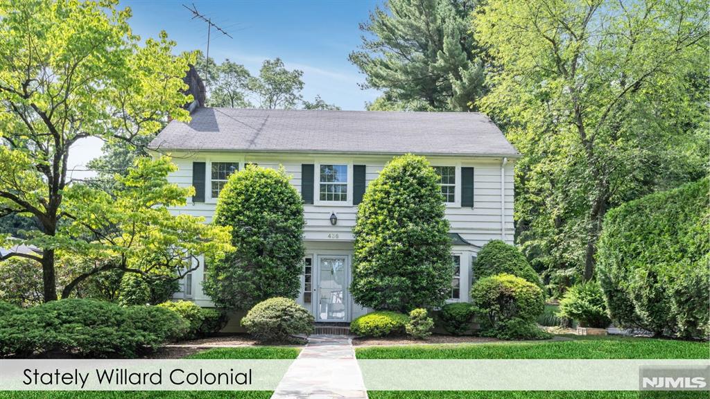 This quintessential Willard Center Hall Colonial offers the perfect blend of time-less character and exceptional living space. Featuring 3 spacious bedrooms and 2.5 baths, the home opens to a gracious entry foyer and beautiful center staircase. The first floor offers an elegant large living room and a cozy wood-burning fireplace. A bright den/office that overlooks the beautiful back yard and access outdoors. The formal dining room with classic wainscoting and bay window is perfect for holidays and evening dinners. The eat-in kitchen overlooks the backyard and connects to the expansive deck. Upstairs the oversized primary suite offers a peaceful retreat complete with a large ensuite bath, while two additional bedrooms provide generous accommodations. A cozy hallway nook is waiting for you to make it your own sweet retreat. A rare walk-out basement provides endless possibilities, while an attached two-car garage adds everyday convenience. This home sits on .3 acres and the backyard offers a beautiful opportunity to create an enchanted garden with a patio and built-in fire pit that create the ideal setting for entertaining.Located in one of Ridgewood's most treasured neighborhoods, just moments from top-rated schools, vibrant downtown shopping and dining, beautiful parks, and convenient NYC transportation, this is a once-in-a-generation opportunity to own a truly special home in one of Bergen County's most coveted communities. Homes like this rarely become available.