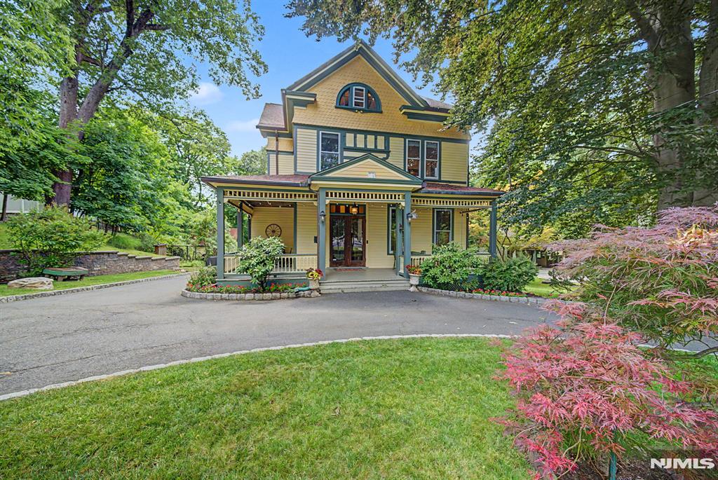 Nestled on a beautiful half-acre property in Tenaflyâ€™s coveted East Hill, this timeless Victorian blends classic old-world charm with modern comfort. A circular driveway welcomes you to a grand foyer showcasing original oak floors, soaring high ceilings, and exquisite architectural details. The main level offers an elegant living room and formal dining room, both with fireplaces, an updated kitchen with butlerâ€™s pantry, powder room, spacious family room, and laundry room. The second floor features a primary suite with private bath, two additional bedrooms, a home office, and a full hall bath. The fully finished third floor serves as an additional bedroom with its own full bathroom, offering exceptional flexibility for guests, extended family, or a private retreat. The renovated lower level includes a recreation area, office, and a modern full bathroom with a steam shower. A detached 2-car garage with a walk-up second-floor loft provides excellent storage, workshop, or hobby space, complemented by ample driveway parking. Recent updates include a new boiler (2022) and HVAC system (2023). Set on a private, park-like half-acre with mature landscaping, this special home is ideally located near top-rated schools, parks, and downtown Tenafly.
