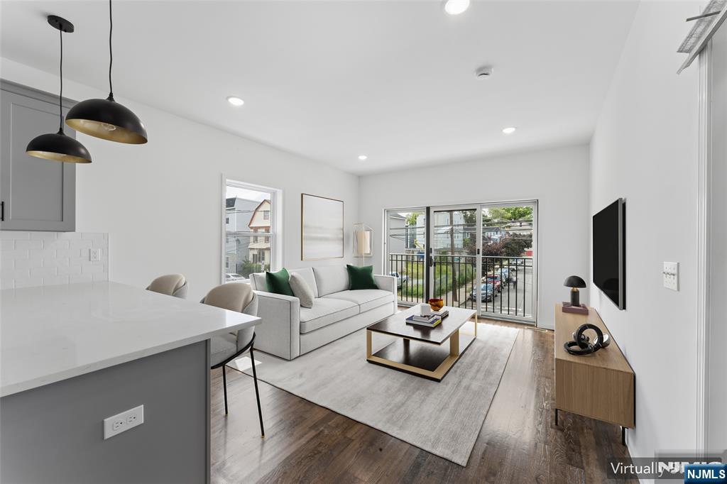 Brand new construction with a private garage and a rare ground-floor bonus living space, this kind of square footage simply doesn't come up often in Newark. Step inside to an oversized studio space with its own bathroom and private entrance. Direct interior access to your private garage. Upstairs, you'll find three generous bedrooms and two full bathrooms, all finished with brand-new fixtures and flooring. In-unit washer and dryer included. Shared backyard for grilling, gardening, or unwinding outdoors. Easy access to major highways, minutes from Weequahic Park, and a short drive to Newark Liberty International Airport. Every surface is brand new. Every appliance is brand new. You're the first to call it home.