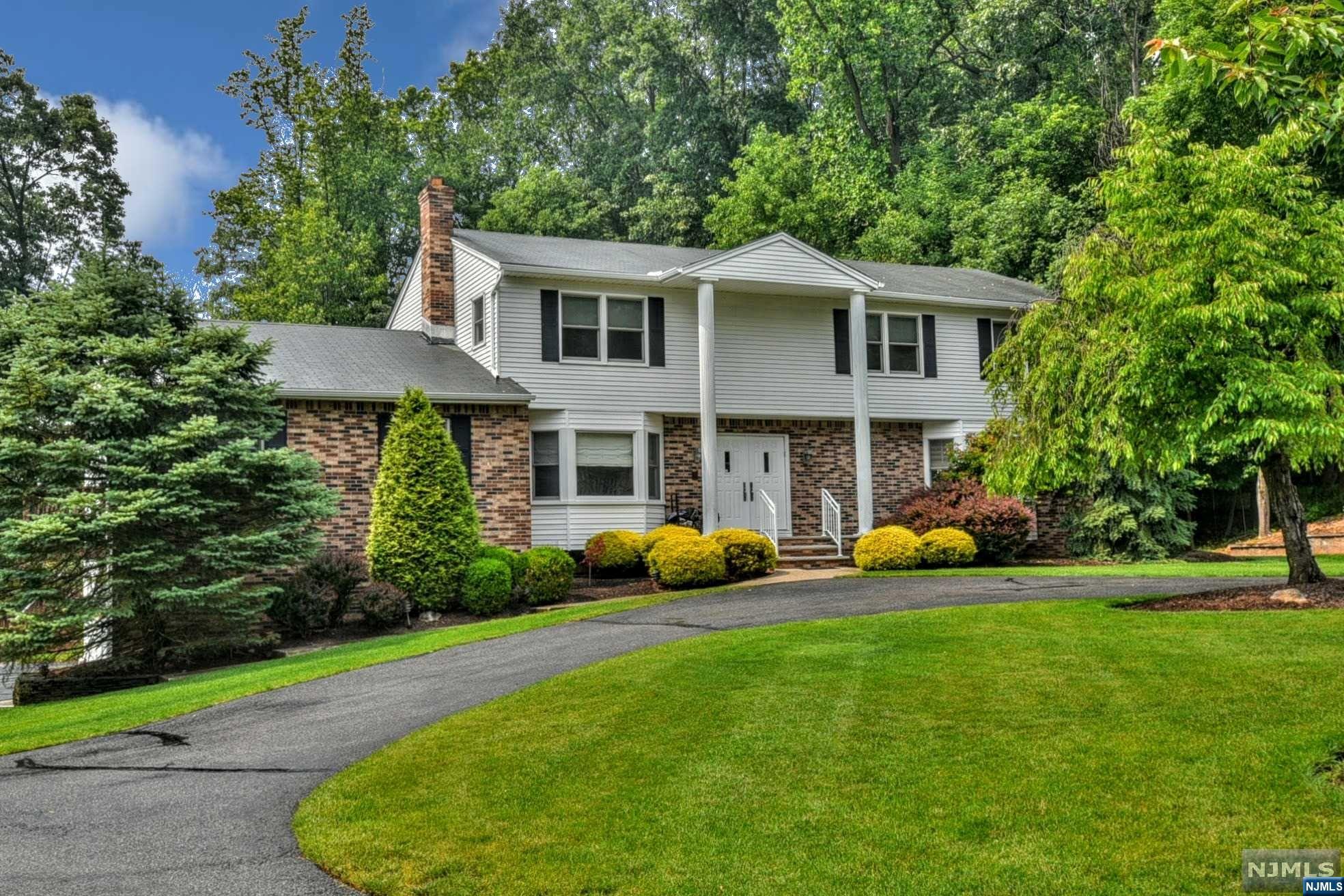Welcome to 395 Faletti Circle. This Center Hall Colonial home features a stunning backyard with a free-form pool, natural stone waterfall, hot tub, outdoor speakers, built-in refrigerator and surrounded by luscious landscaping. A huge deck with two BBQ's overlooking the pool make this property a fabulous Summer retreat for entertaining or quiet solitude. The interior of the home boasts a Chef's kitchen with Custom Cabinetry and high-end appliances. In addition there is a Great Room with wood-burning fireplace, Living Room, Office/Den, 28' Banquet-size Dining Room with fireplace, bedroom, full bathroom with walk-in shower and laundry. Second floor has 4 king-size bedrooms. The home is located at the end of a quiet cul-de-sac and features a circular driveway. This home can be your retreat for the summer and years to come!