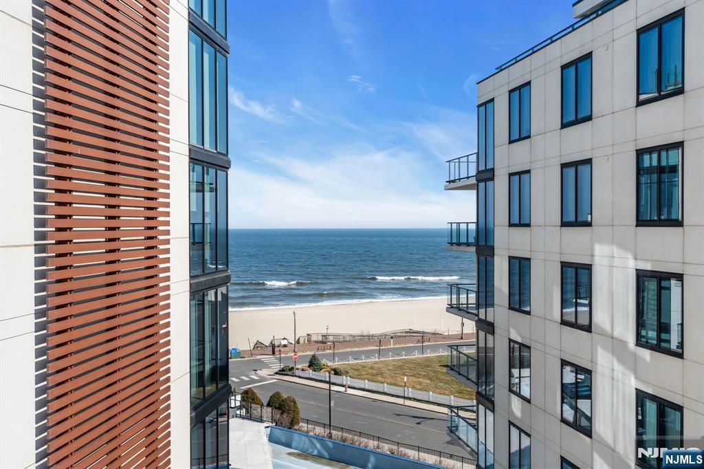 Elevated in every sense, this high-floor residence offers the coastal lifestyle you've only dreamed of - in one of the Jersey Shore's most converted addresses. Stunning floor-to-ceilingglass walls, importedfrom Italy, set a striking tone for this remarkable oceanfront showplace at South Beach. Residence 603 is a rare chance toembrace refined coastal living in Long Branch's most soughtafter beachfront enclave. Oriented to take in expansive AtlanticOcean panoramas, the home is bathed in natural light and thoughtfully designedfor effortless shore living. An openfloor plan connects generous living and dining spaces to a private terrace featuring outdoor gas fireplaces, where ocean breezes and uninterrupted horizon views create an atmosphere of everyday indulgence. The showpiece chef's kitchen is designed by Snaidero, Wolf &Sub-Zero appliances, induction cook-top,built-in wine refrigerator,water filtration system and premium finishes complete this sophisticated design with serious culinary functionality 3 spacious bedrooms are complemented by spa-style bathrooms with Kohler fixtures, offering a serene escape just steps from the sand Meticulous attention to detail and luxury-grade finishes and built-ins throughout strike the perfect balance between luxury and laid-back coastal charm. Situated in a full-service oceanfront building with elevator access and top-tier amenities, residents are moments from the beach, Pier Village, acclaimed restaurants, and the energy of the waterfront.